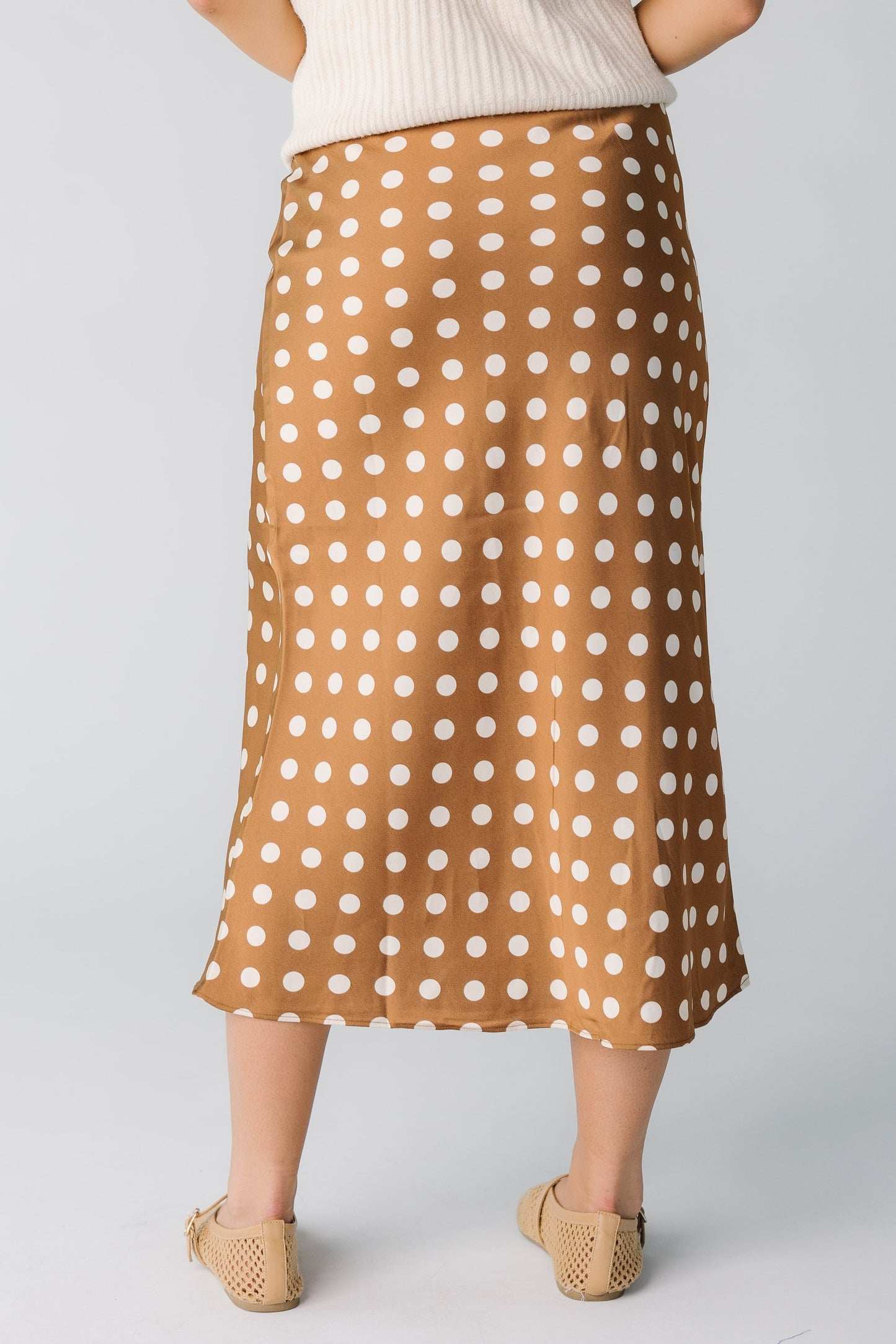Back view of brown and white polka dot midi skirt