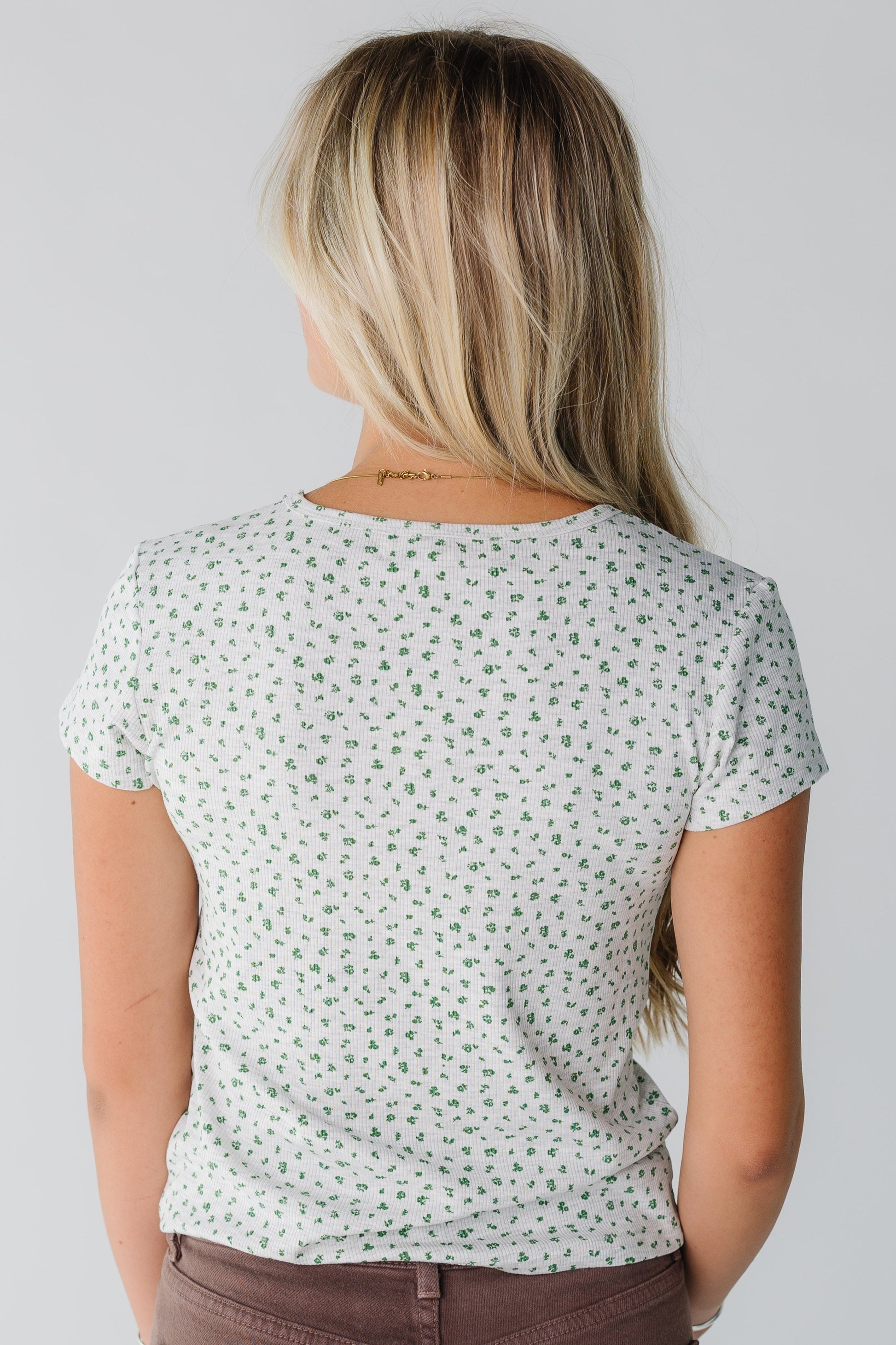 Back view of grey floral top with short sleeves