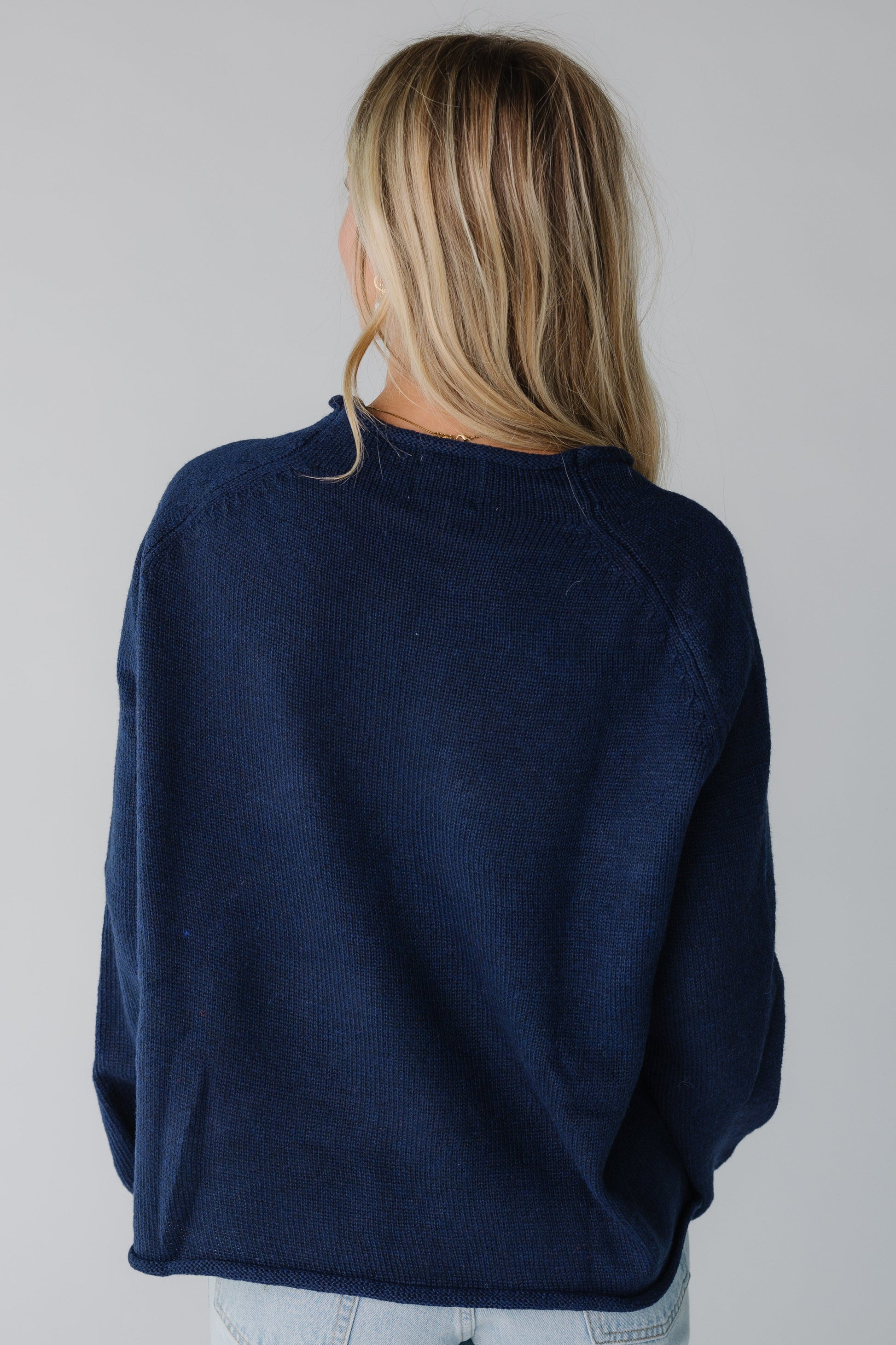 Back view of navy loose fitting sweater