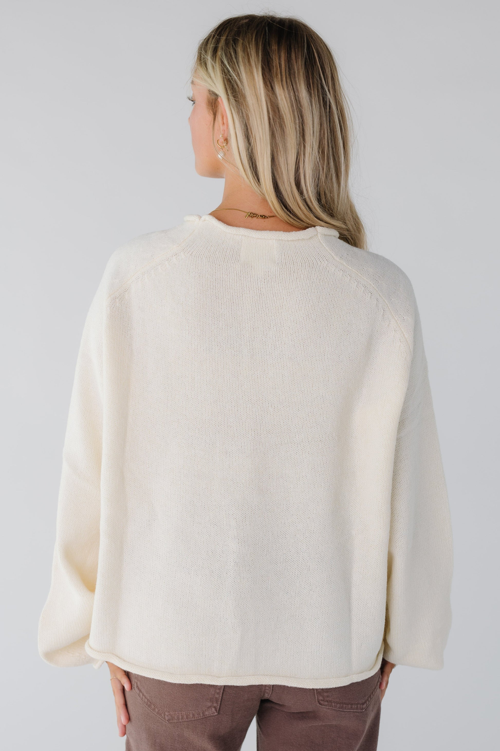 Back view of ivory loose fitting sweater