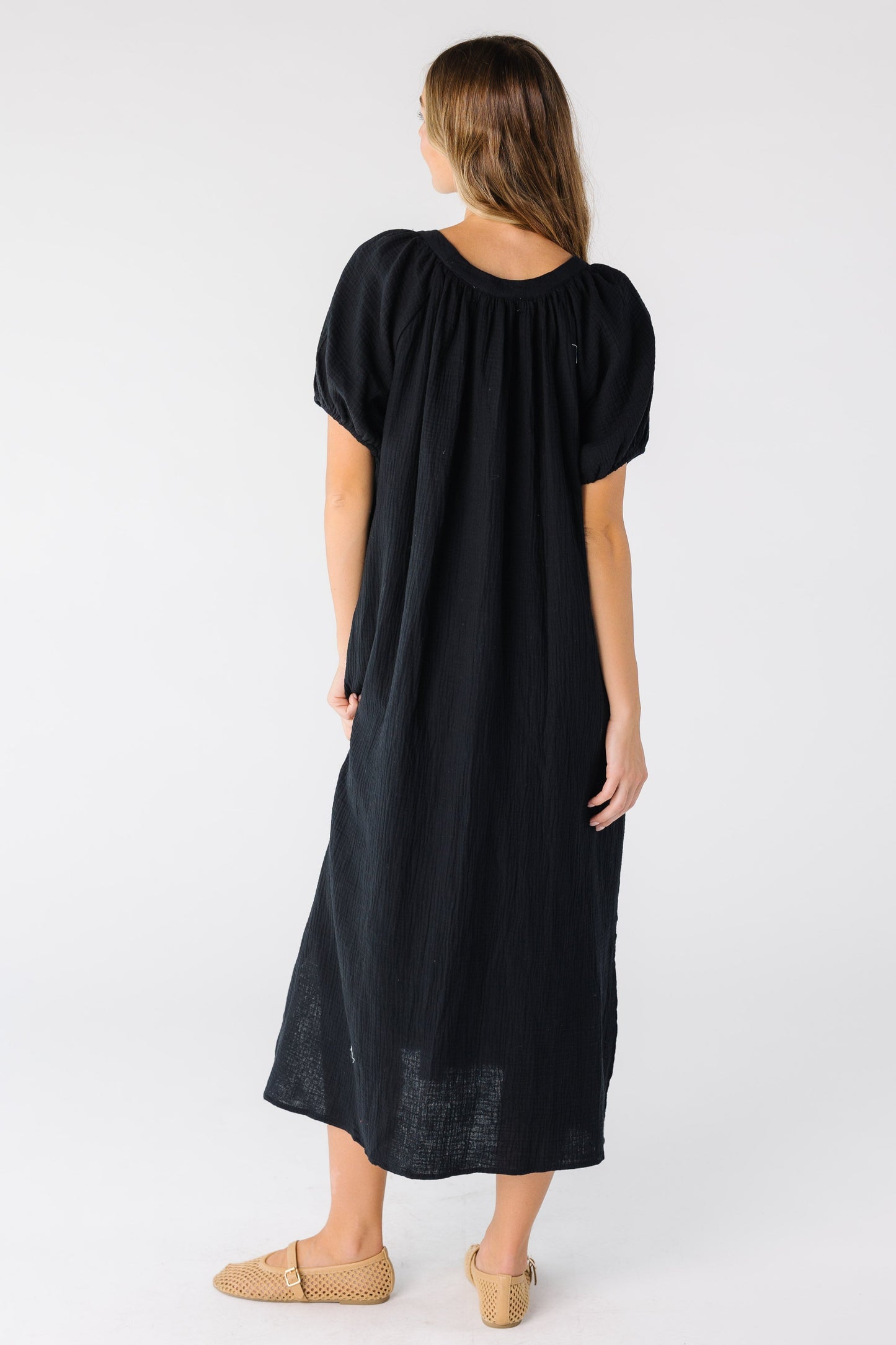 Back view of a black midi dress with short sleevs