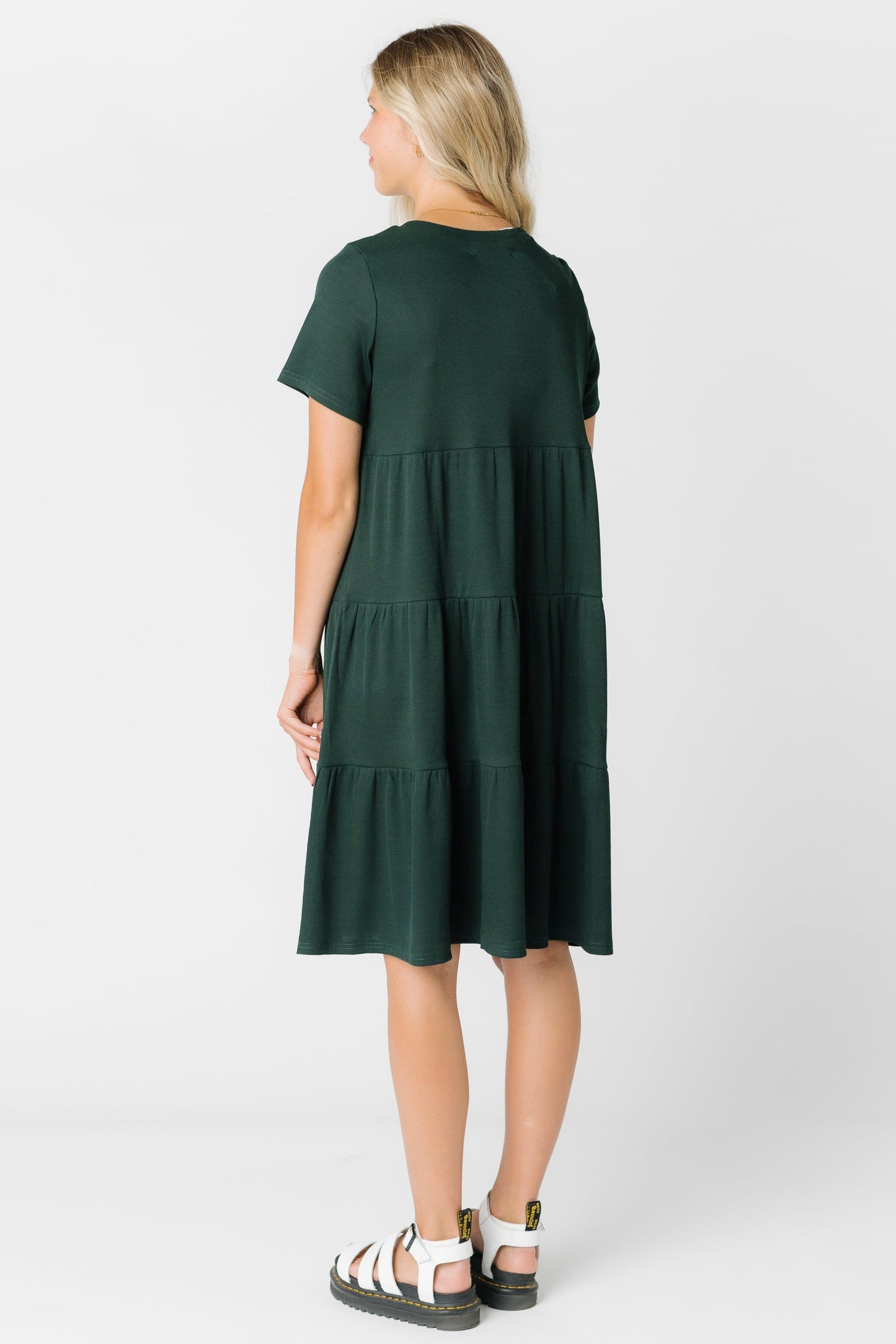 Back view of woman wearing a green tiered dress