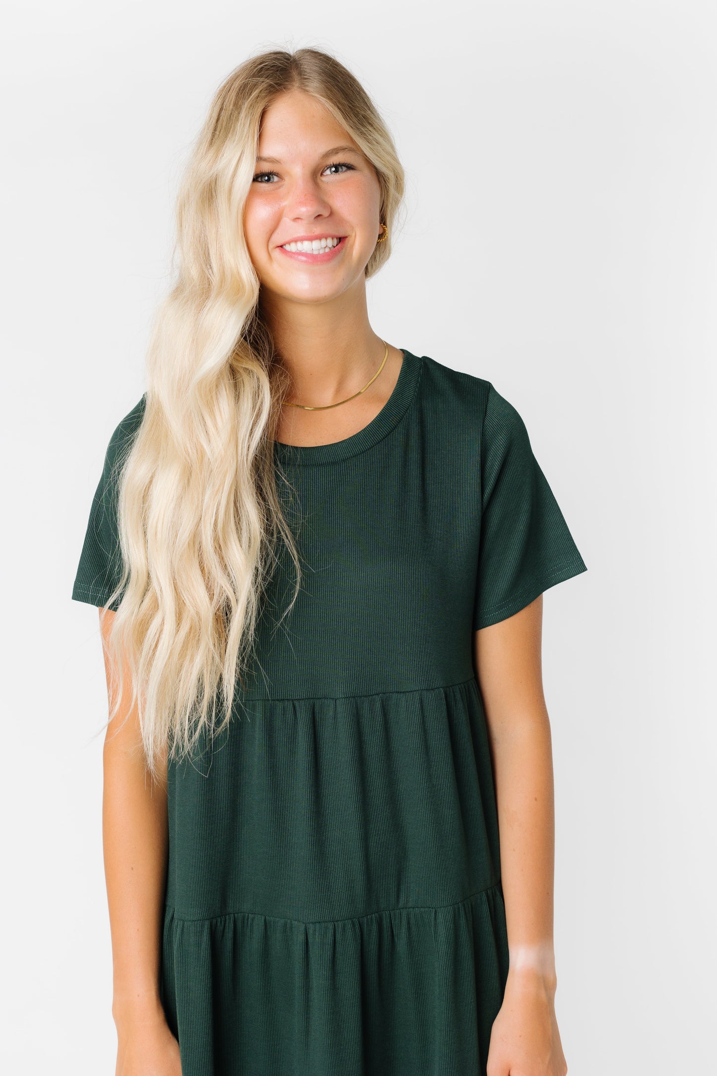 Close view of a woman in a dark green dress with short sleeves