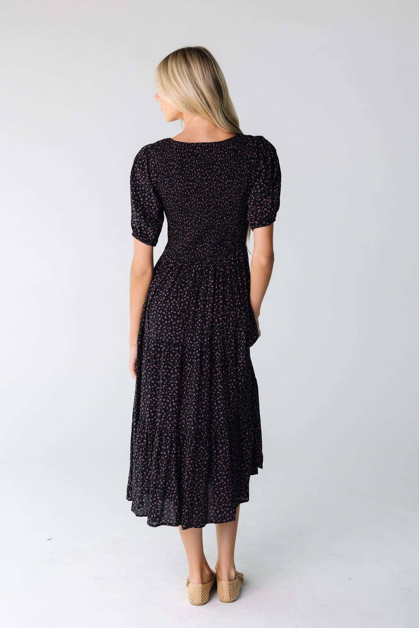 Back view of a black print dress with short sleeves