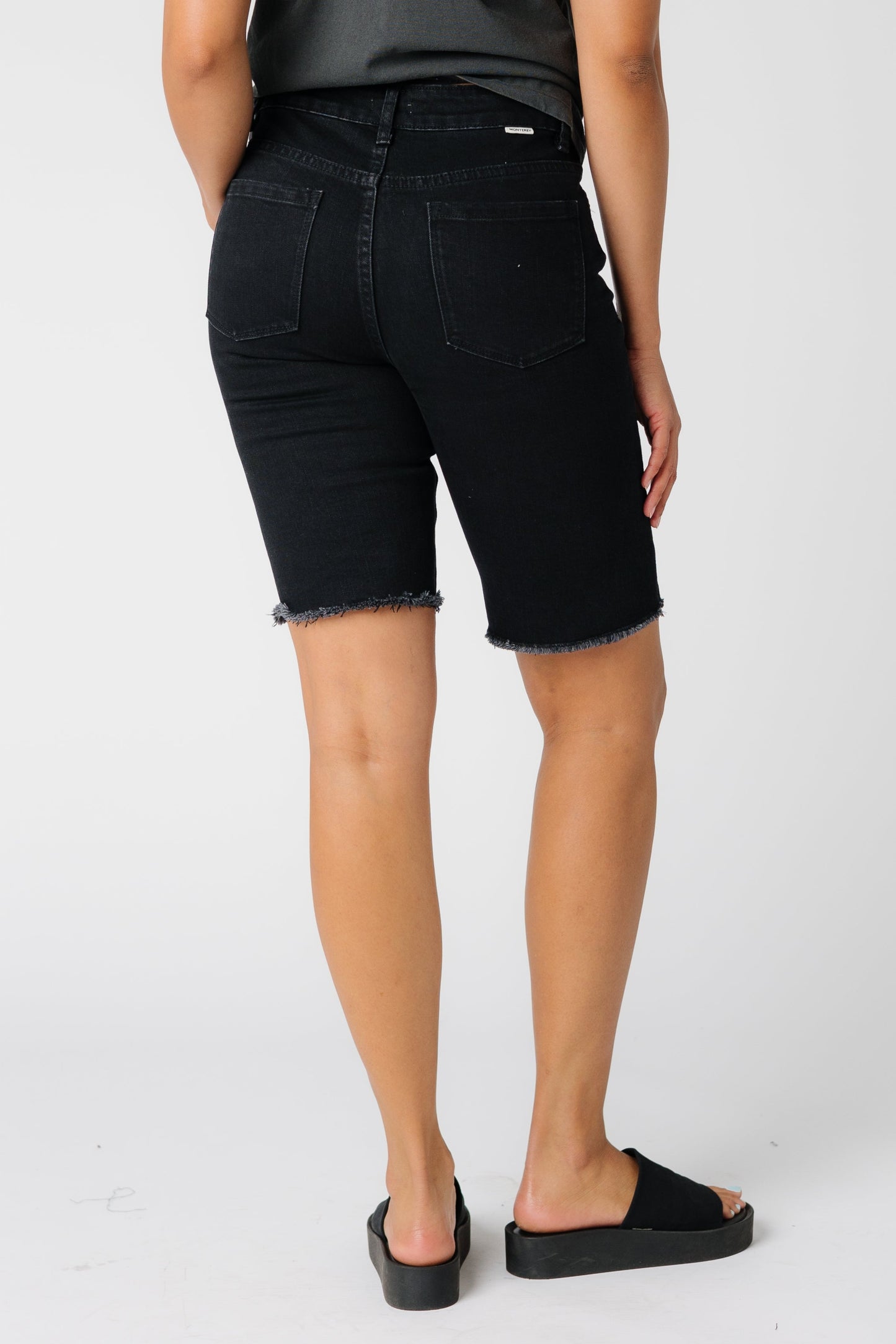 Back view of long black denim shorts
