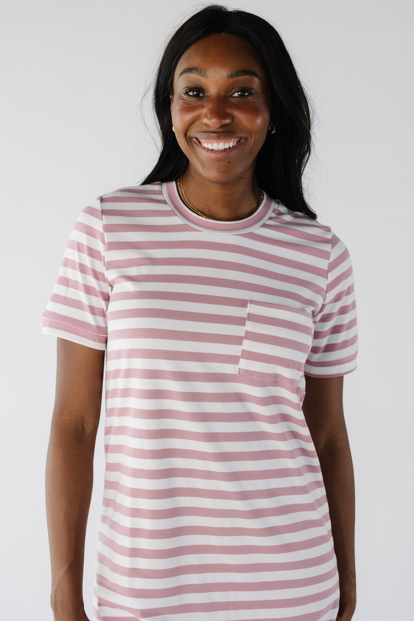 Close view of pink and white t-shirt dress with single patch pocket