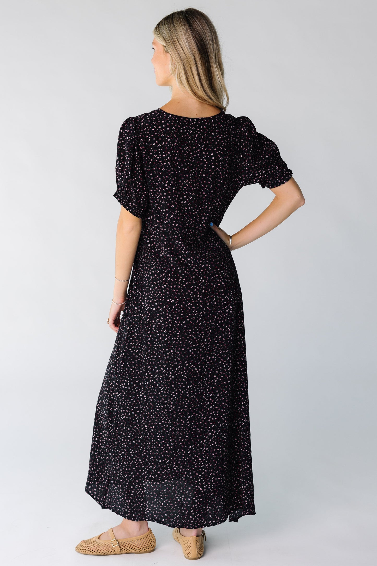 Back view of a woman wearing a black print midi dress