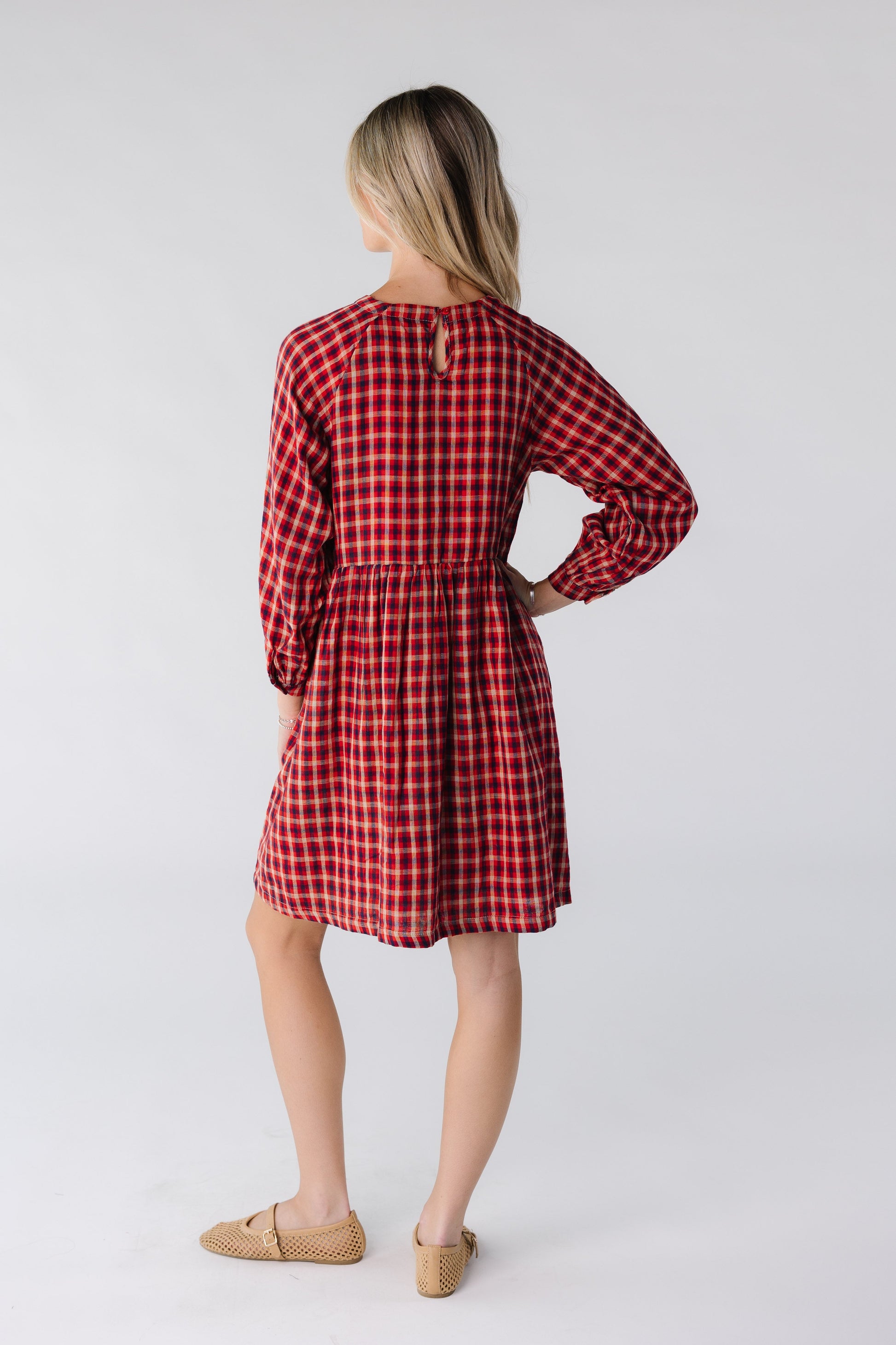 Back view of a woman wearing a red plaid dress