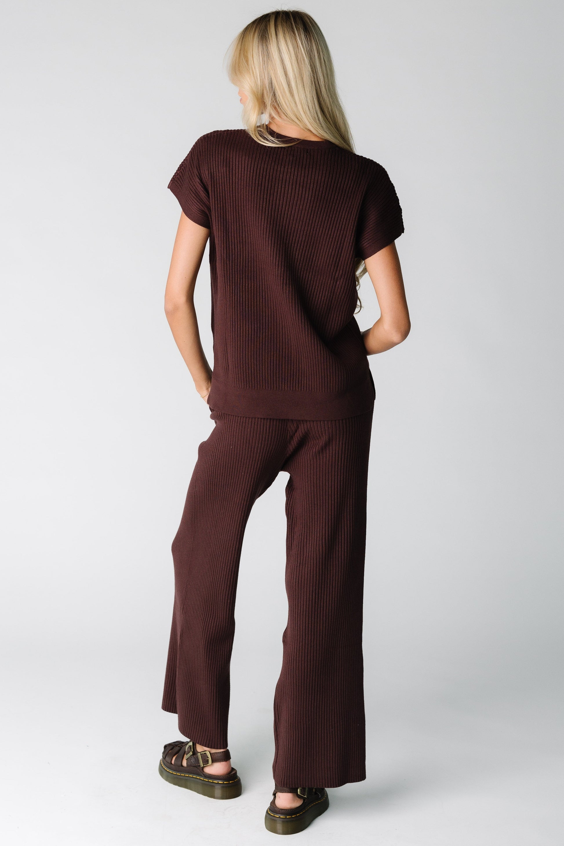 Back view of a woman wearing a brown ribbed sweater set