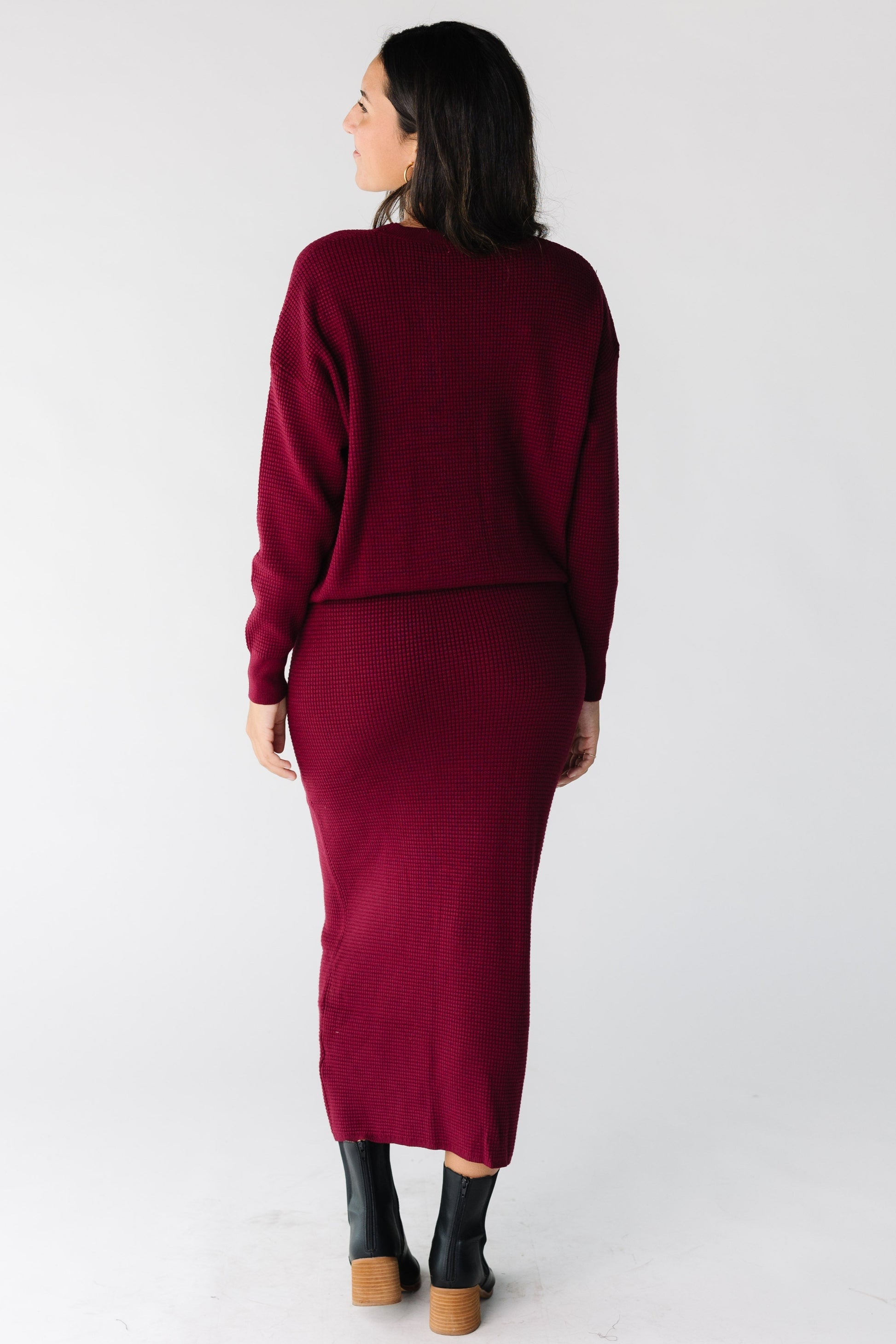 Back view of a woman wearing a w piece sweater skirt set