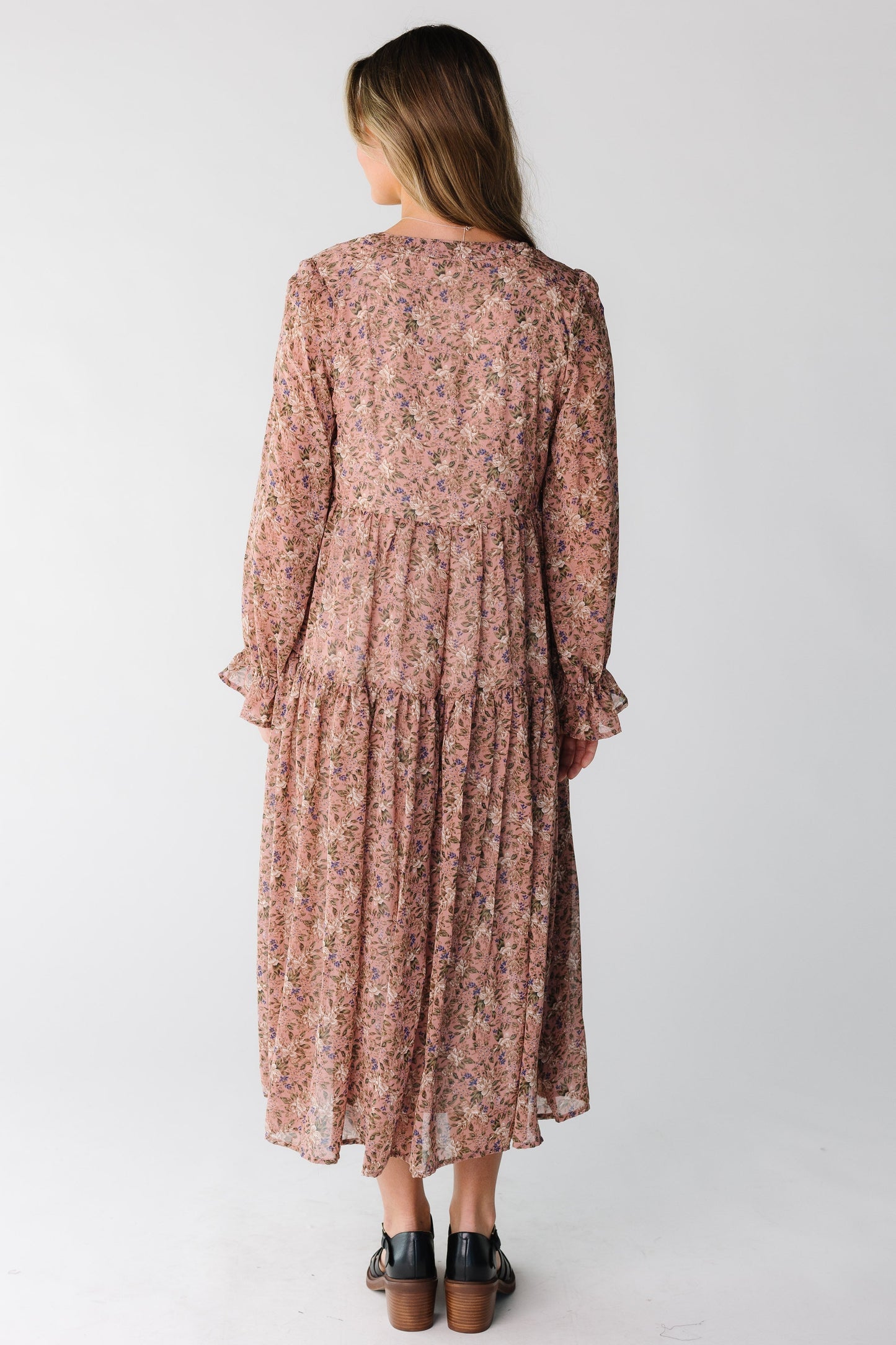Back view of a woman wearing a mauve floral midi
