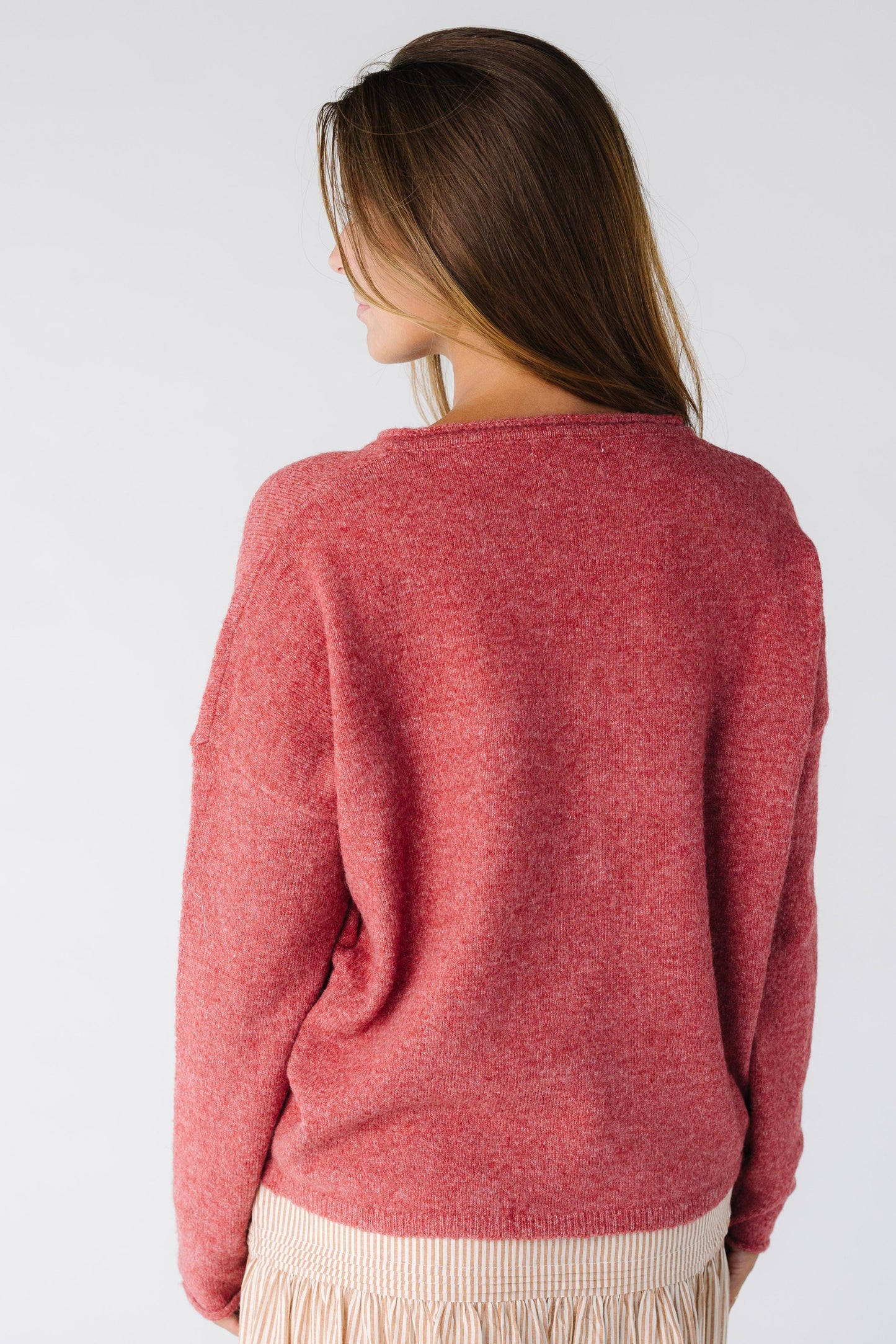 Back view of a woman wearing a berry long sleeve cardigan