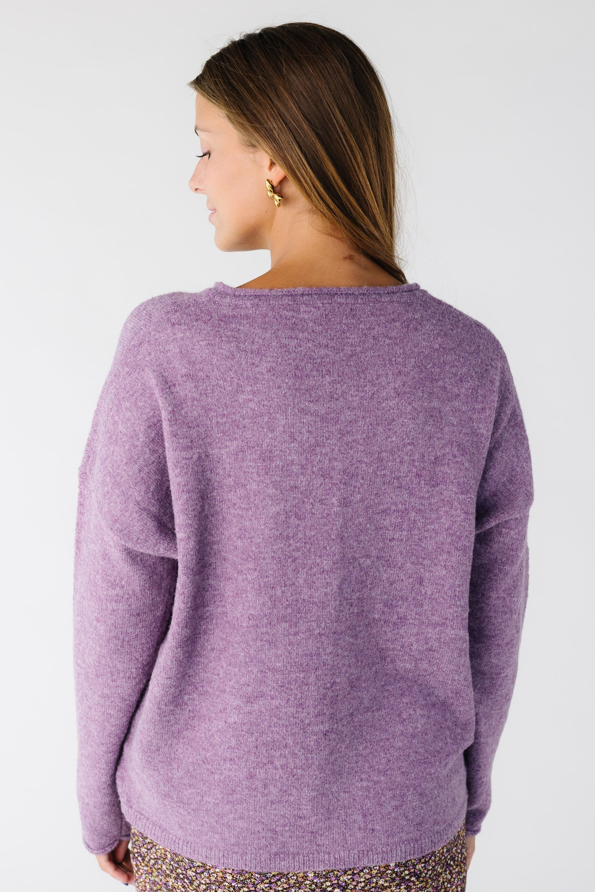Back view of a woman wearing a heathered purple cardigan