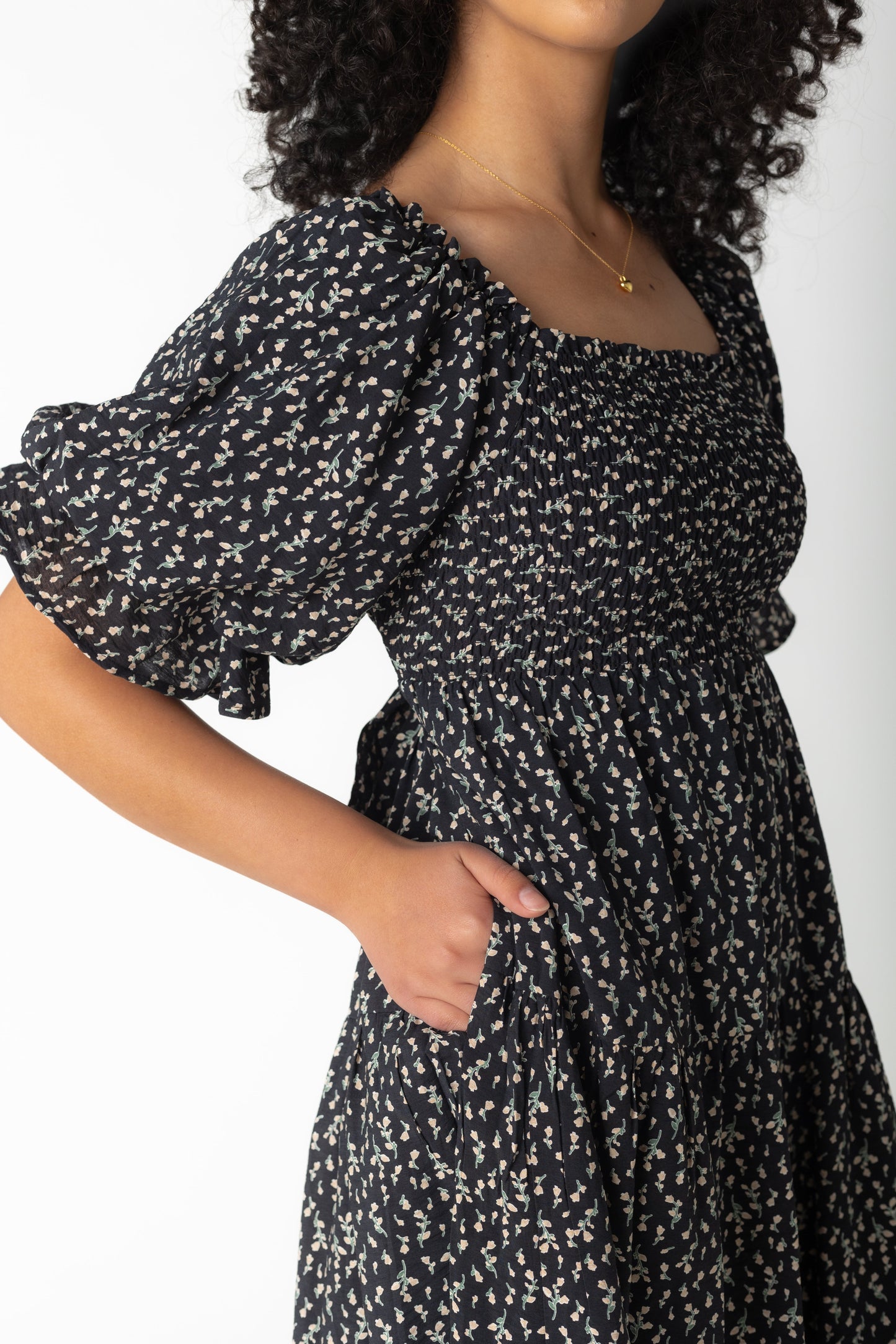 Close view of half length balloon sleeves on black print midi