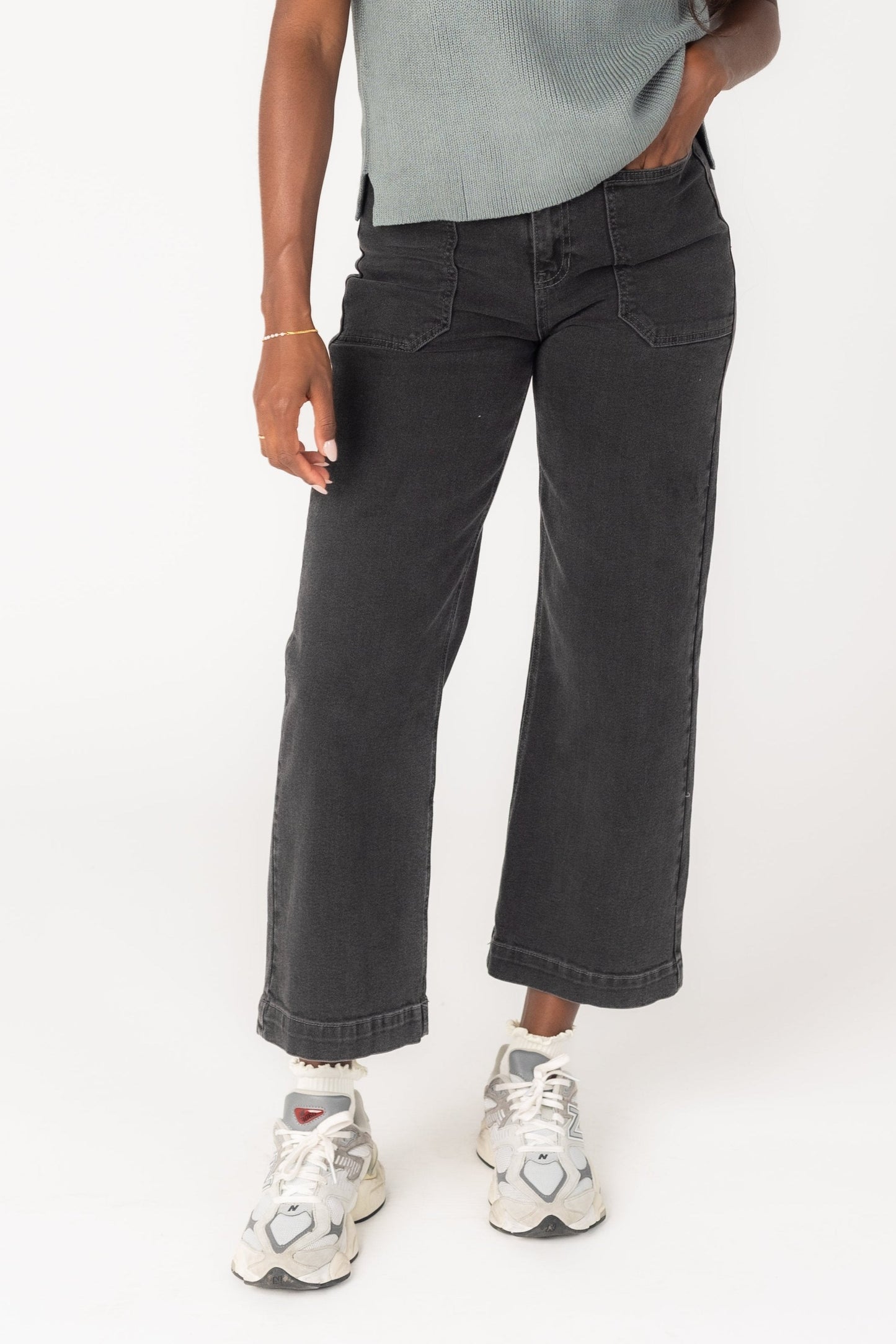 Woman wearing black wide leg jeans with large pockets