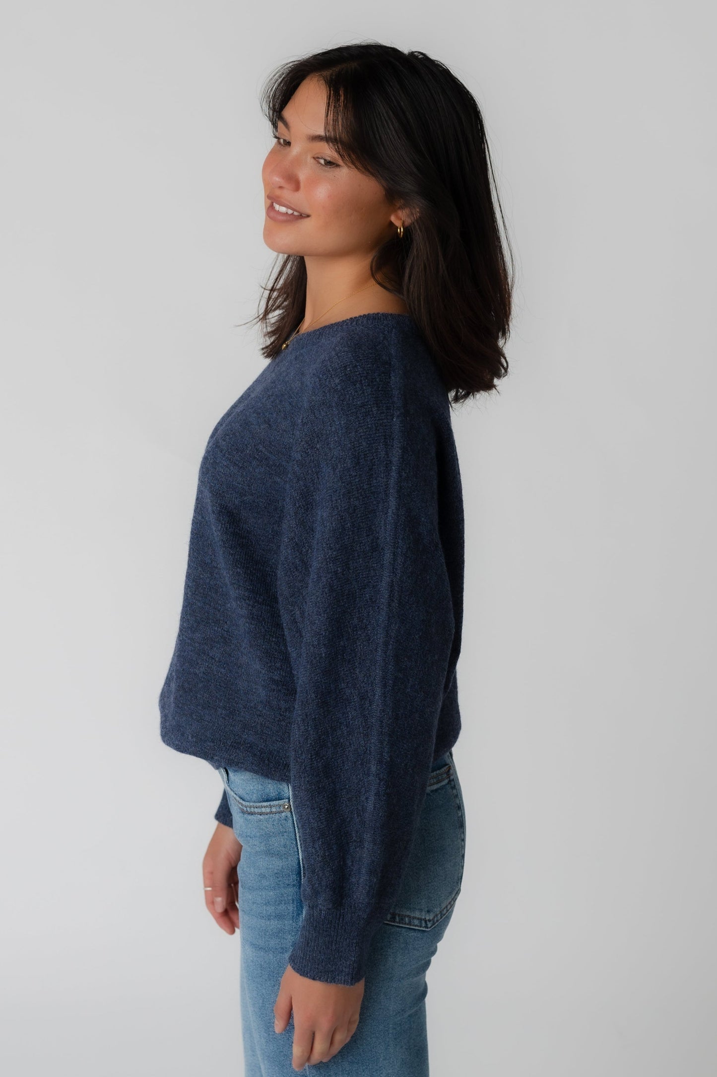 Side view of long sleeve navy sweater