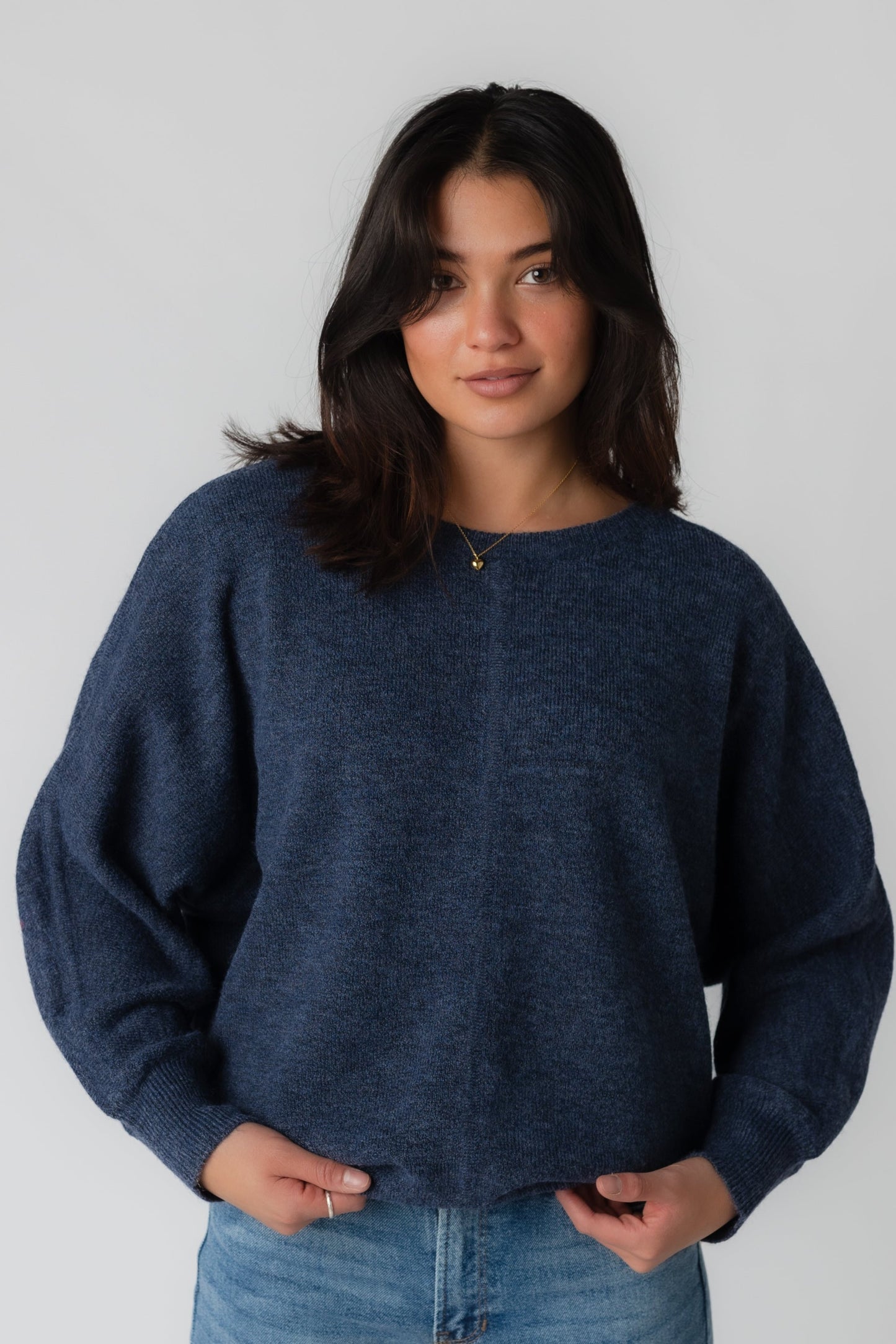 Loose fitting navy sweater with long sleeves and crew neckline