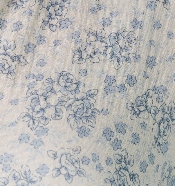 White with blue floral print fabric swatch.