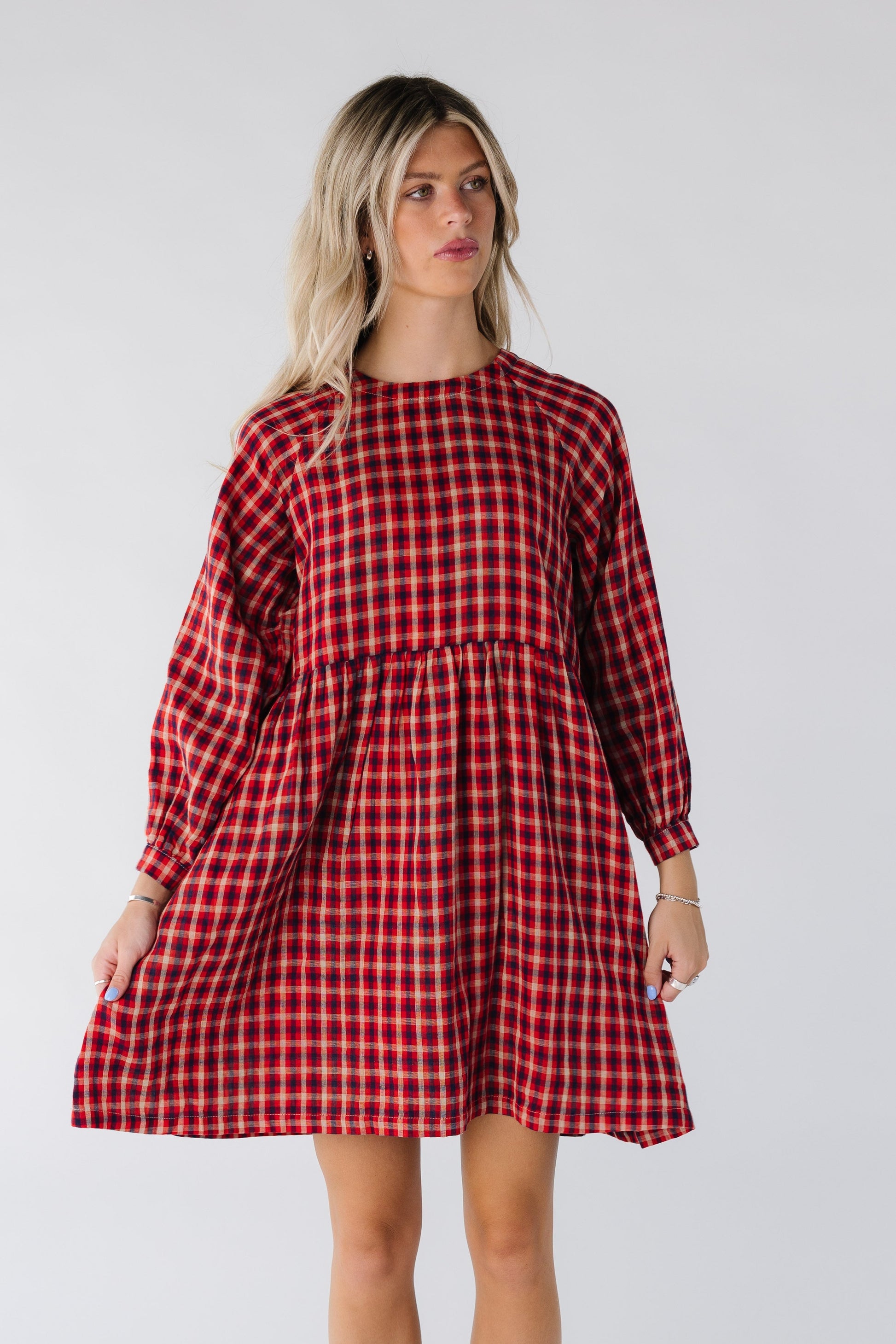 Woman wearing a red plaid dress with long sleeves