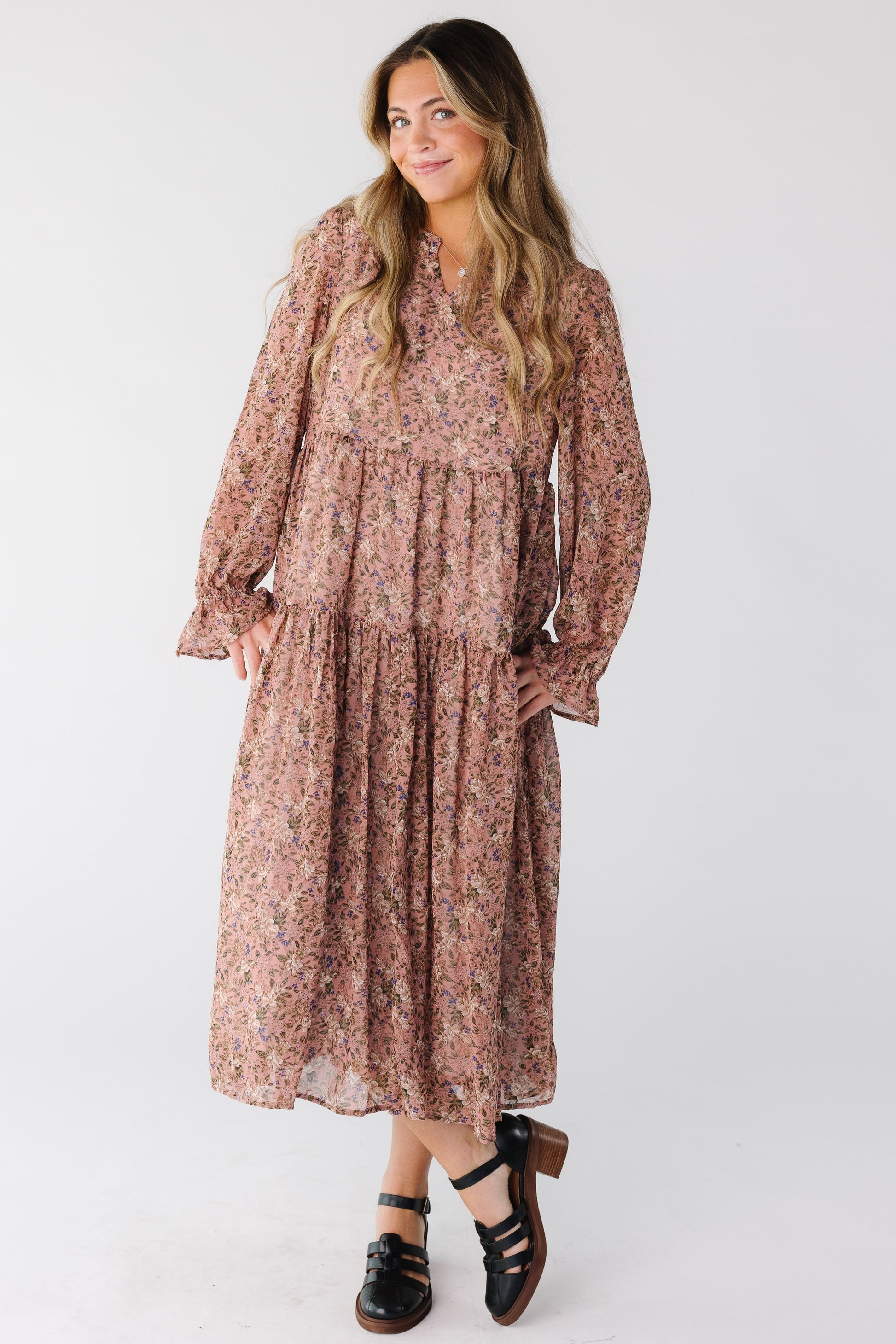 Woman wearing  a mauve floral dress with V-neckline