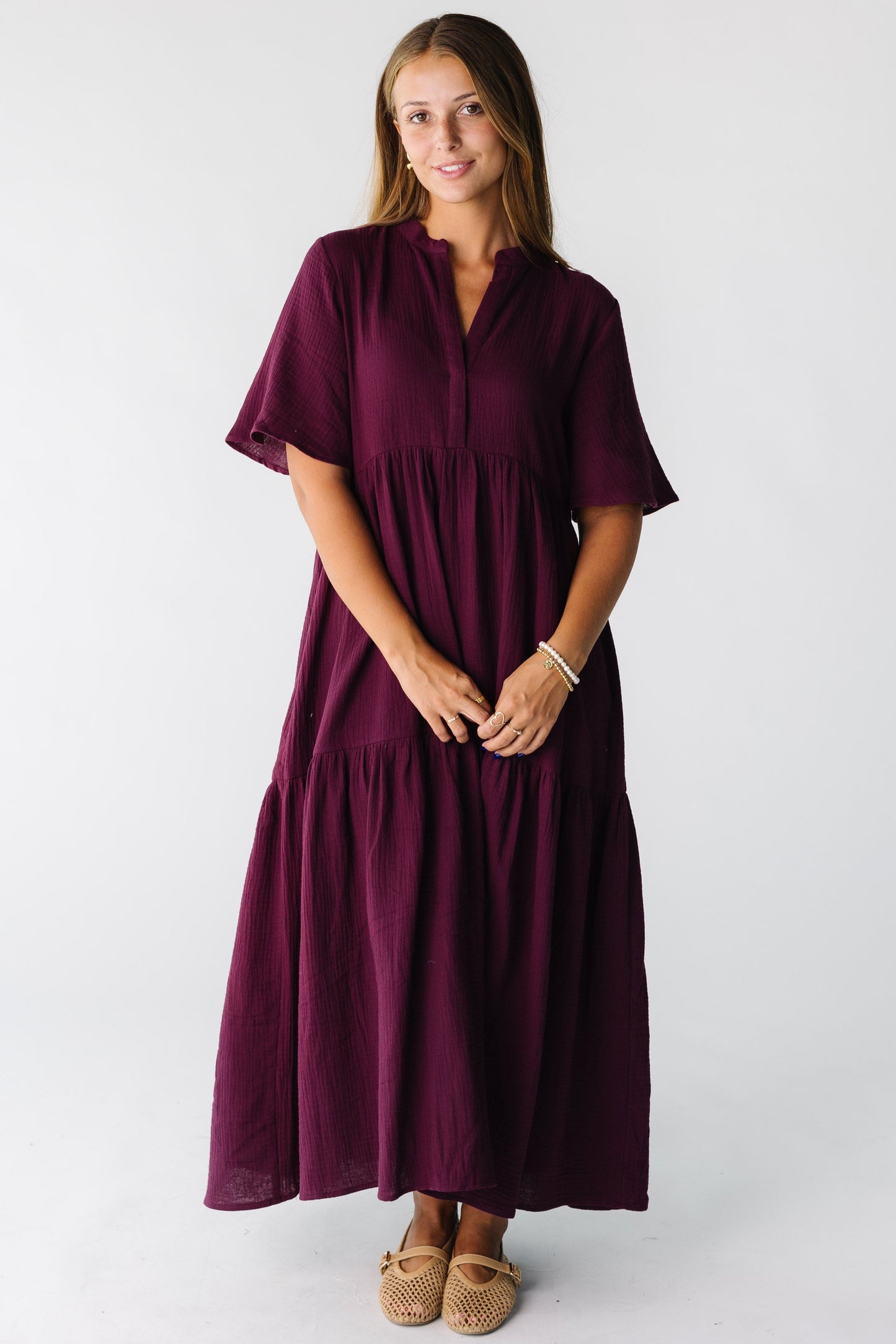 Woman wearing a plum short sleeve midi dress