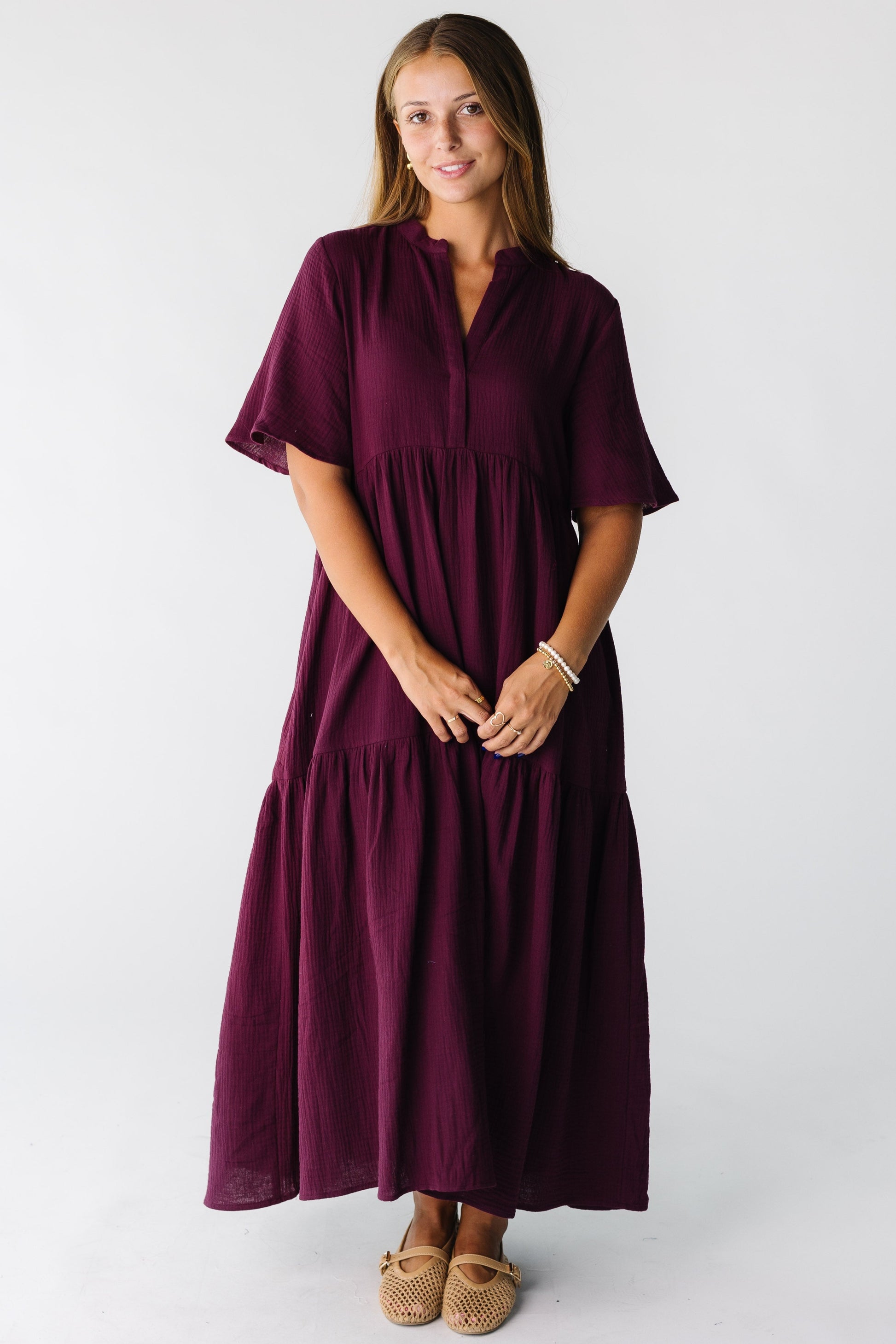Woman wearing a plum short sleeve midi dress