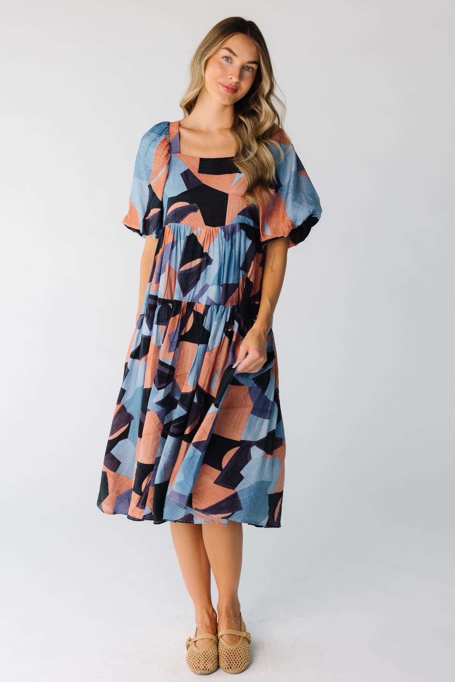 Woman wearing colorful dress with large half length sleeves and full skirt