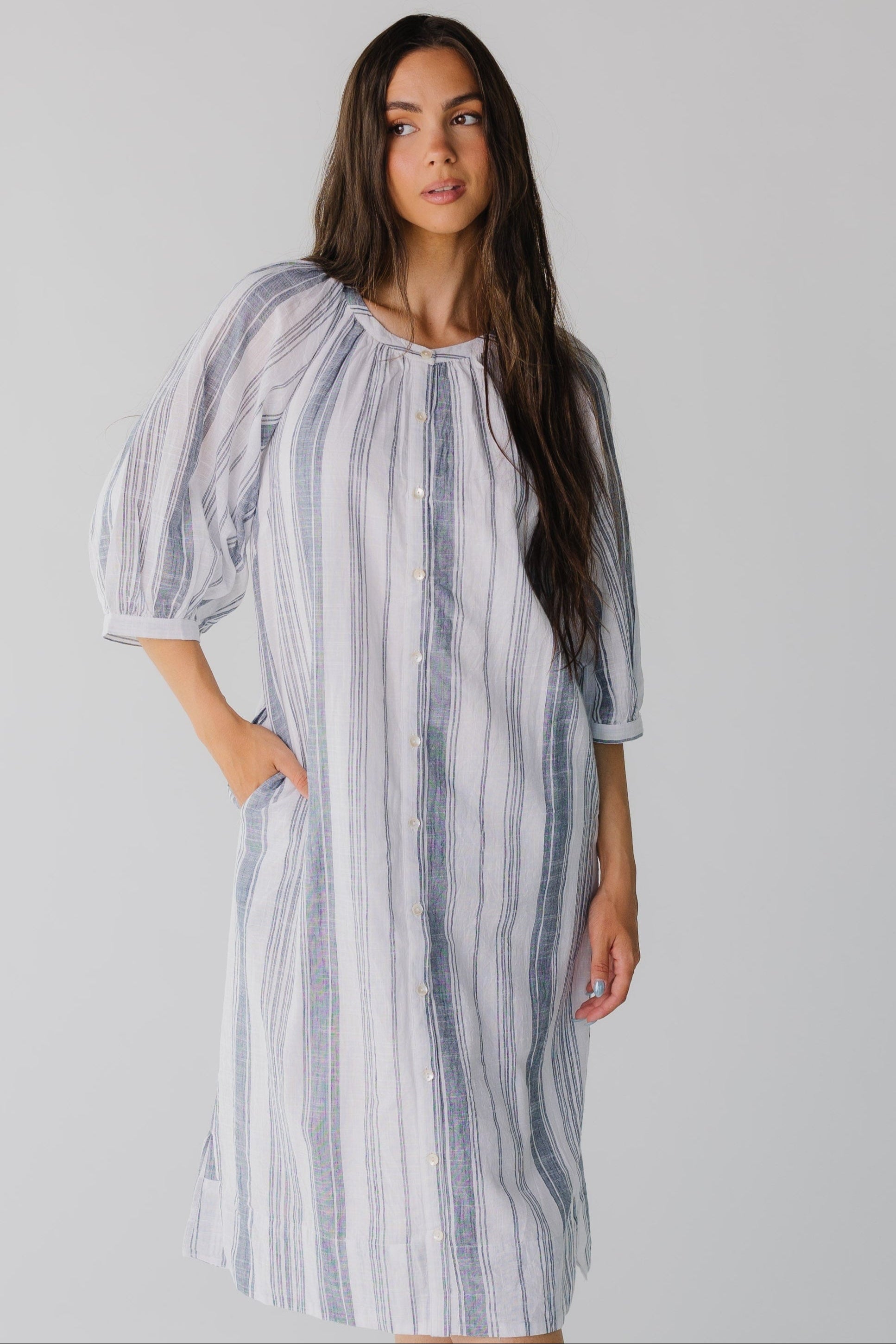 Modest blue and white stripe button down midi dress with three quarter length sleeves and round neck line.