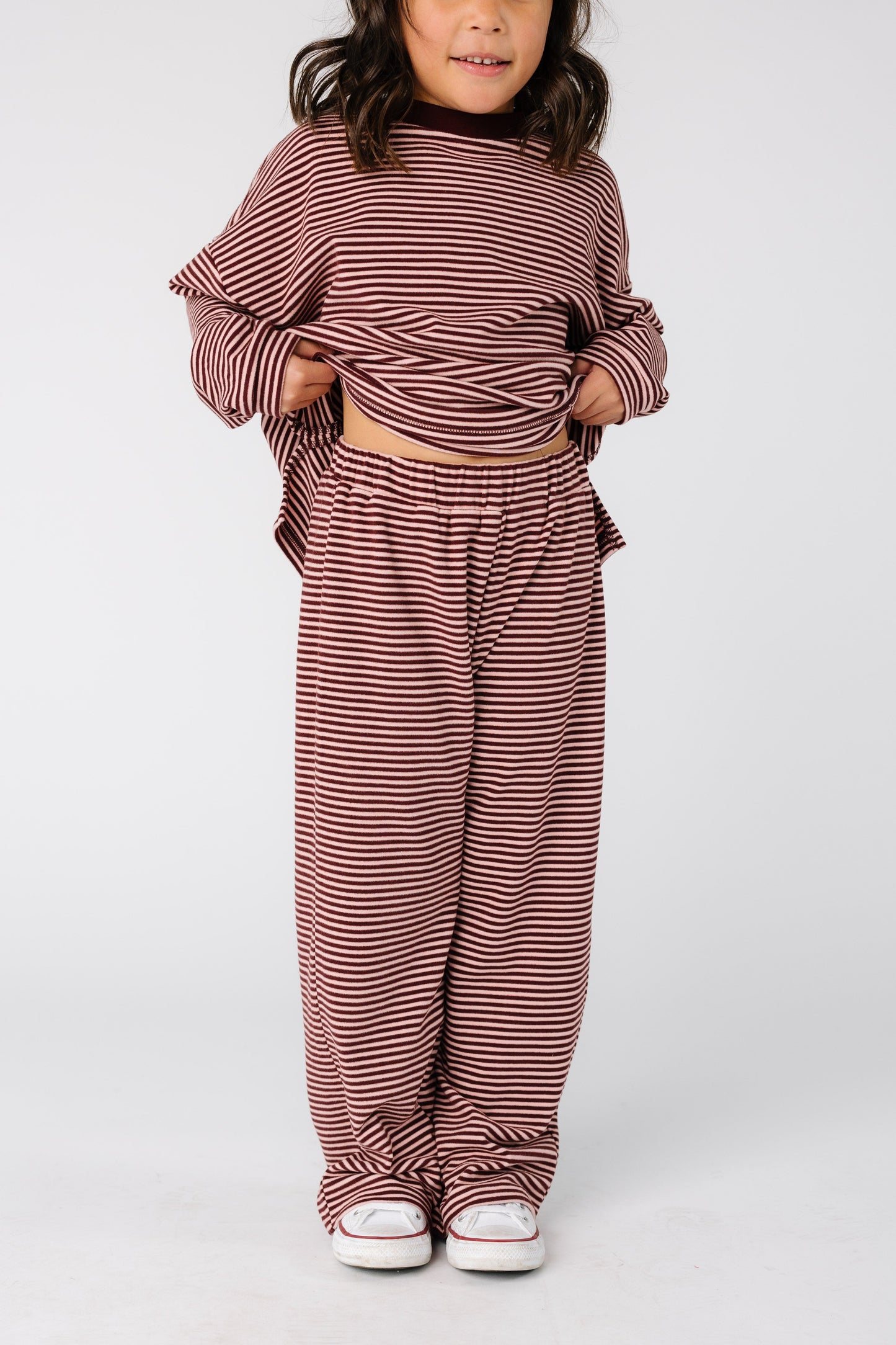 Close view of a girl wearing a burgundy stripe lounge pant