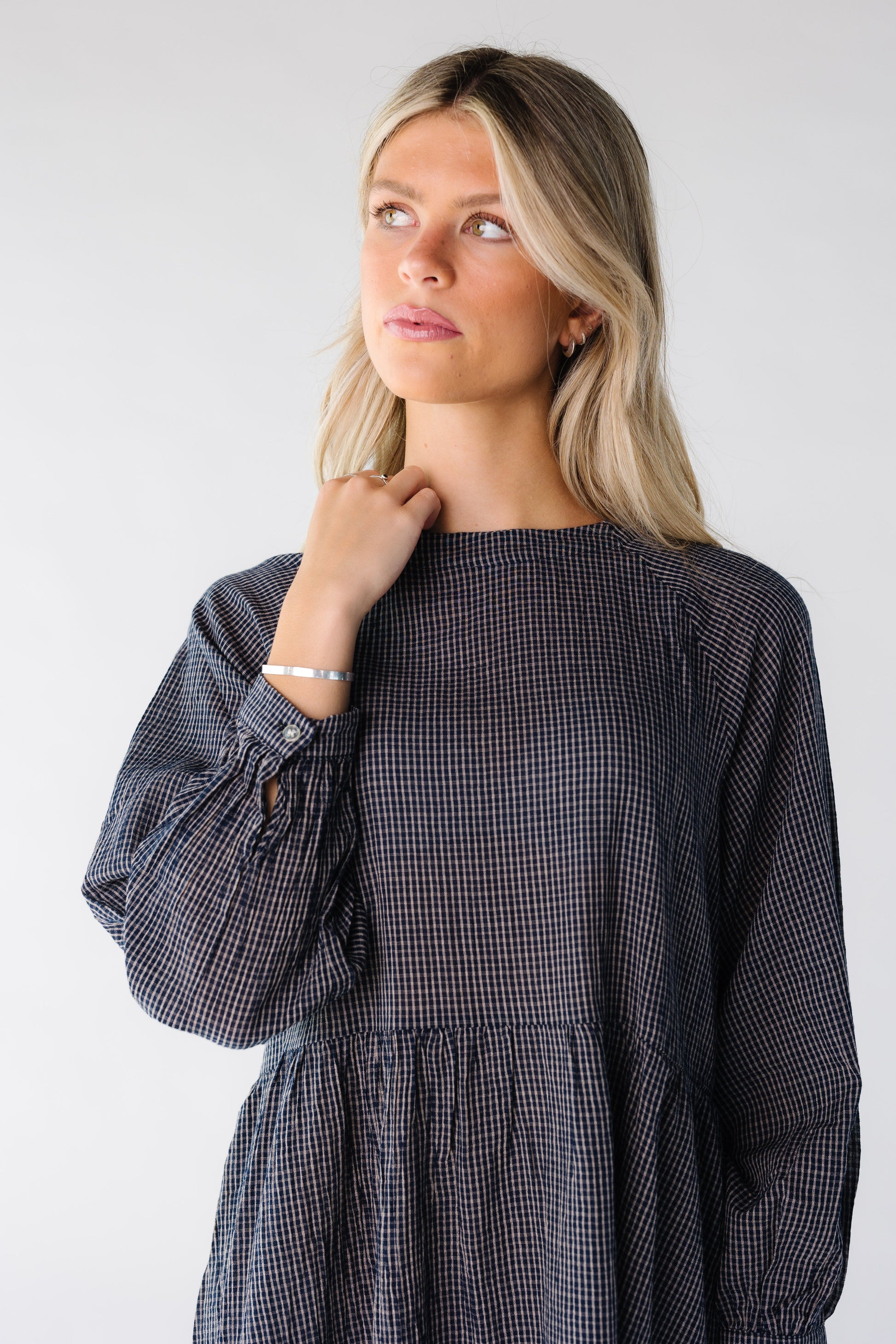 Close view of a woman wearing a navy plaid dress
