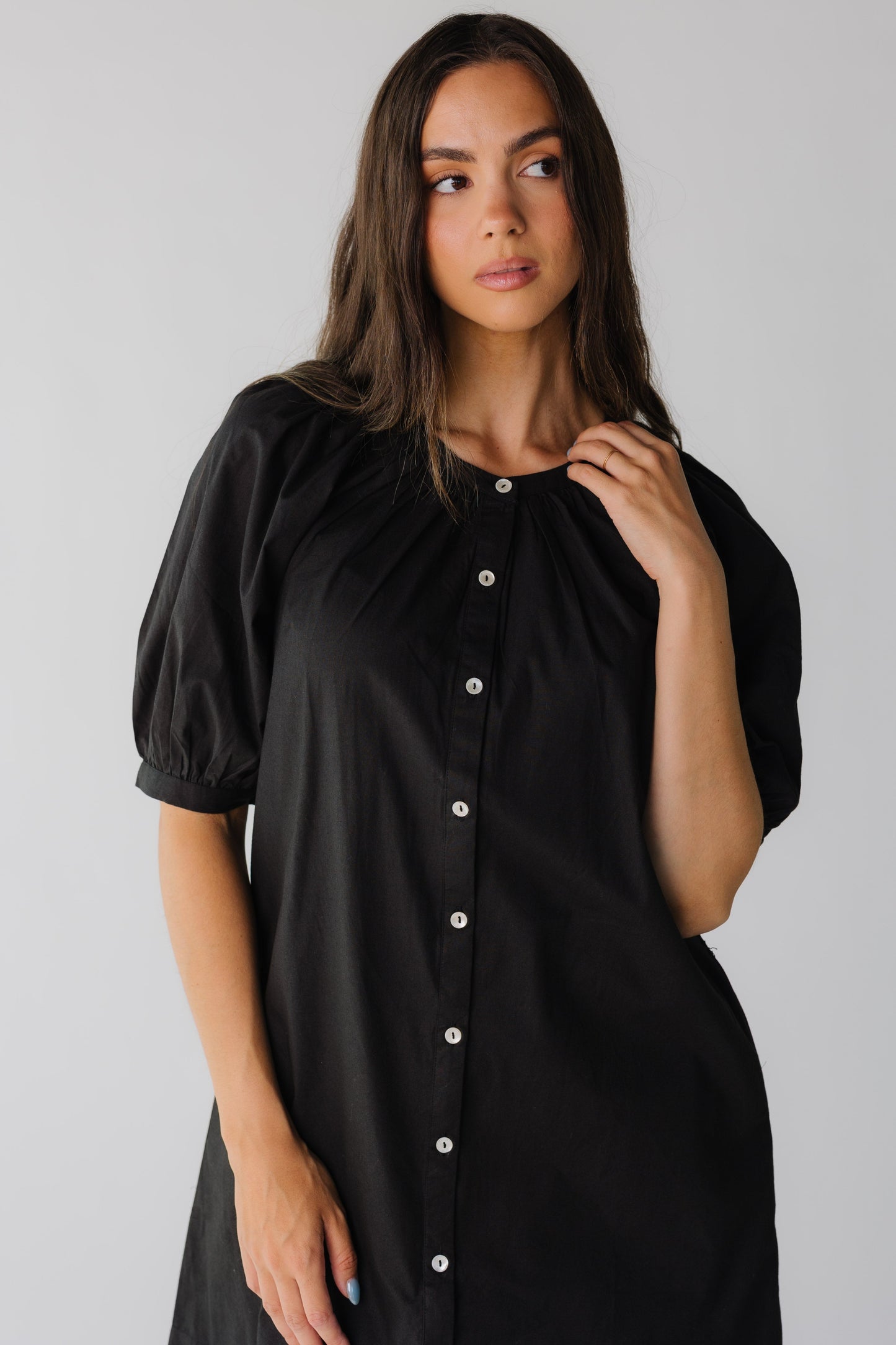 Close view of black knee length dress with elbow length sleeves