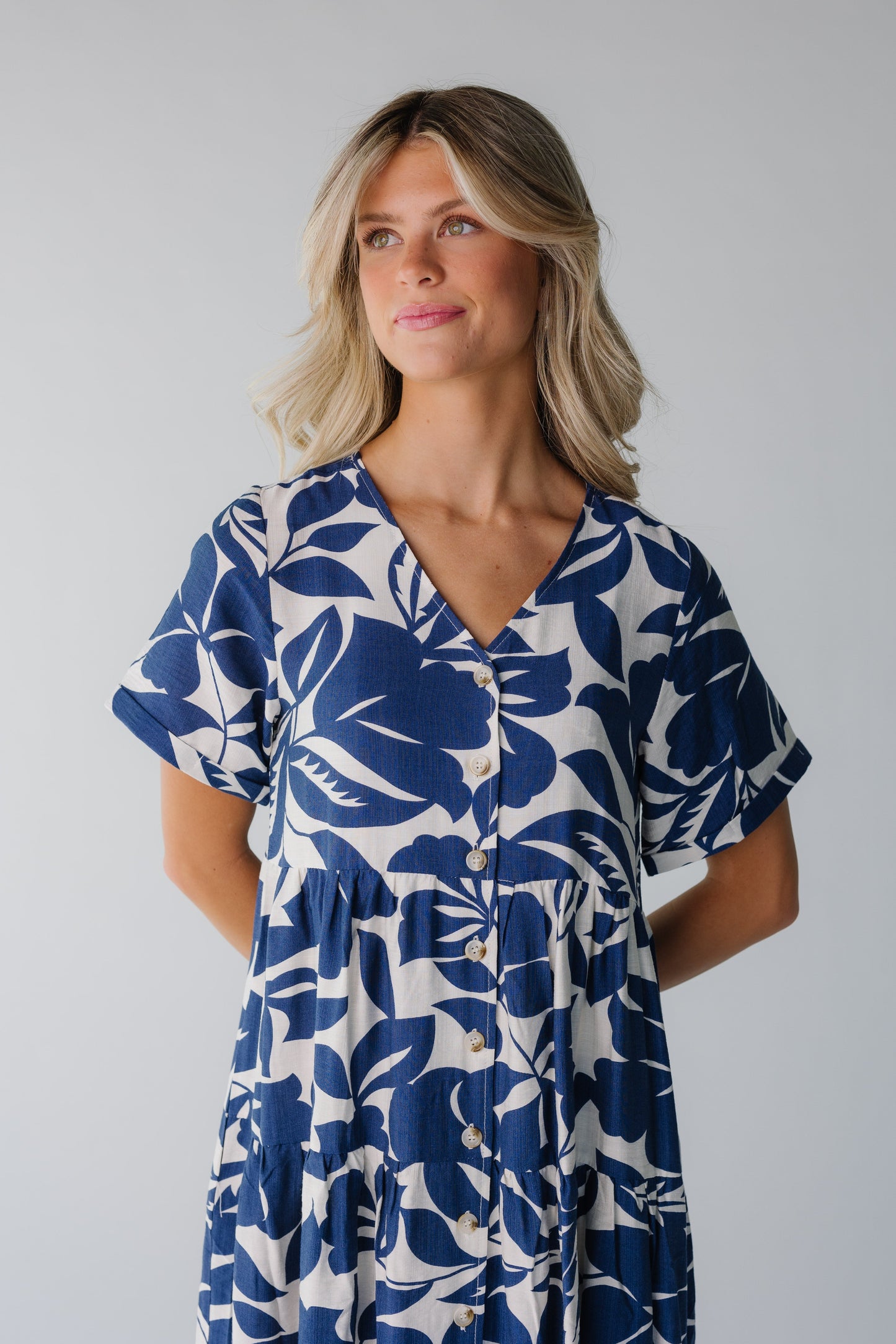 Close view of navy and white button down dress with V-neckline
