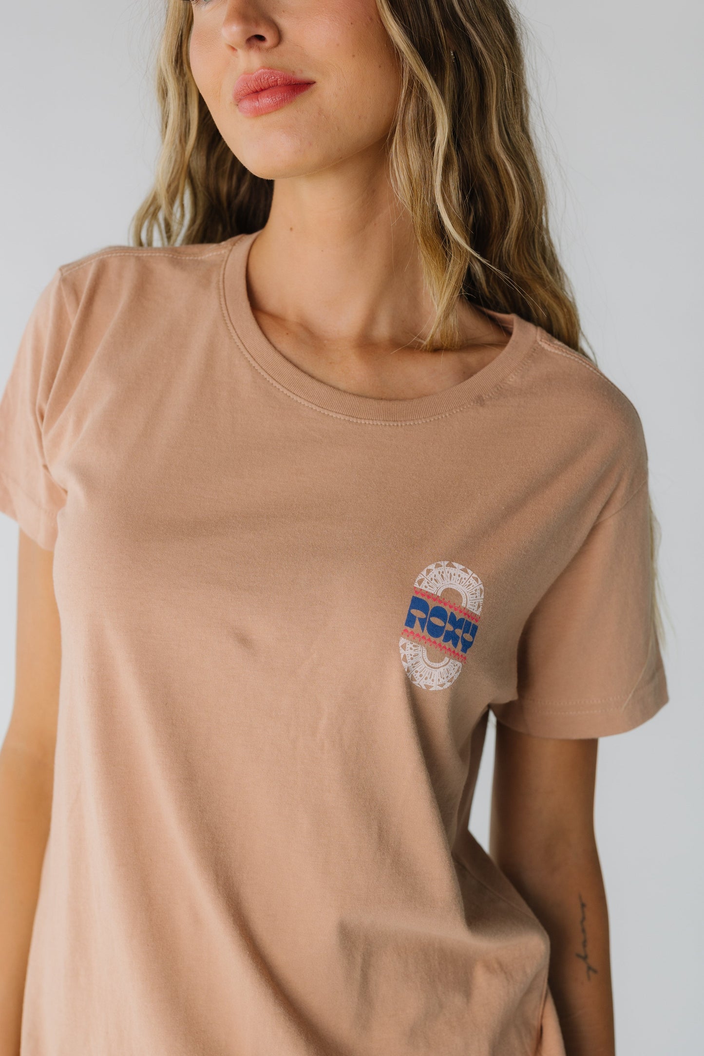 Close view of Roxy Besos graphic tee in tan