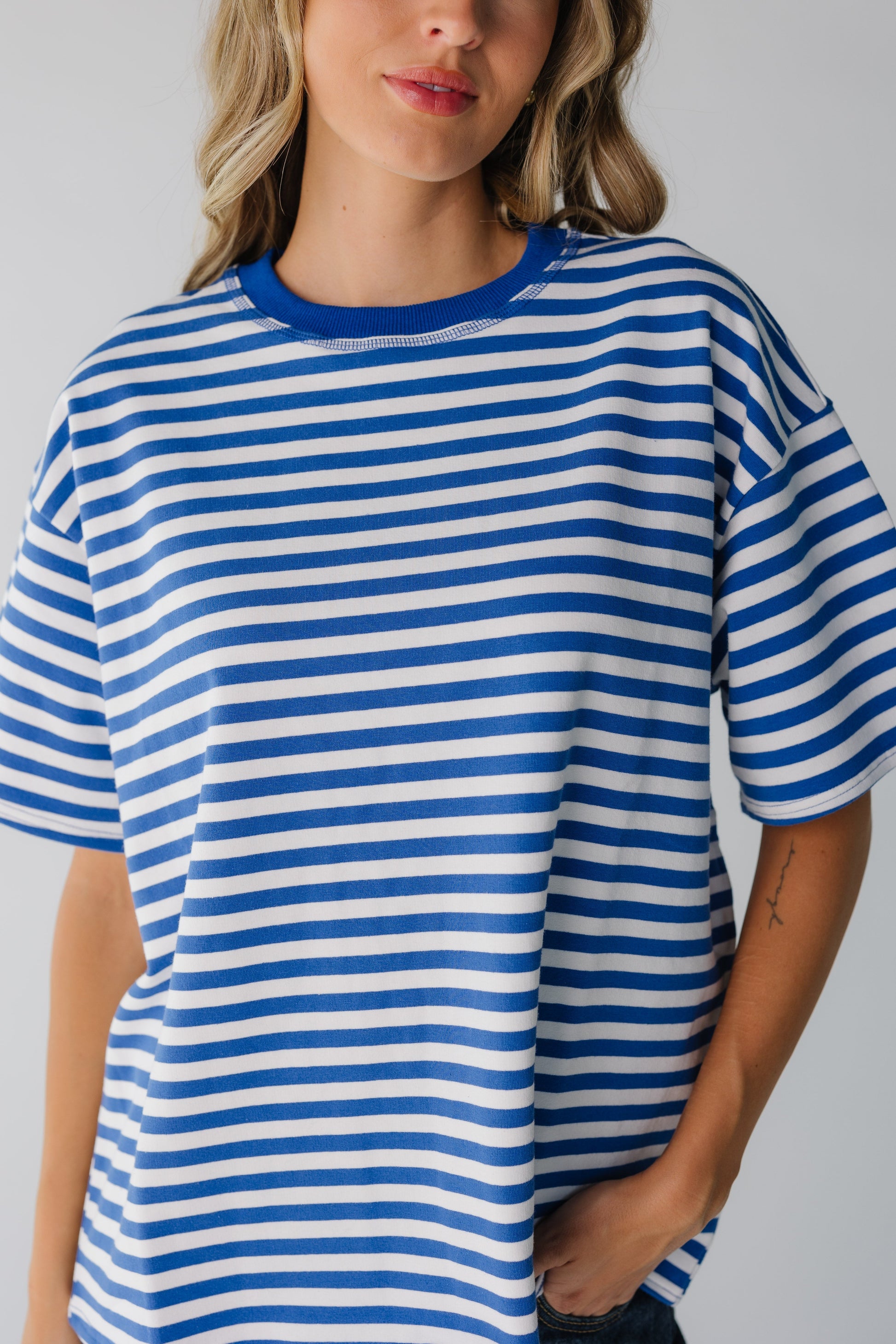 Close view of woman wearing blue and white stripe tee