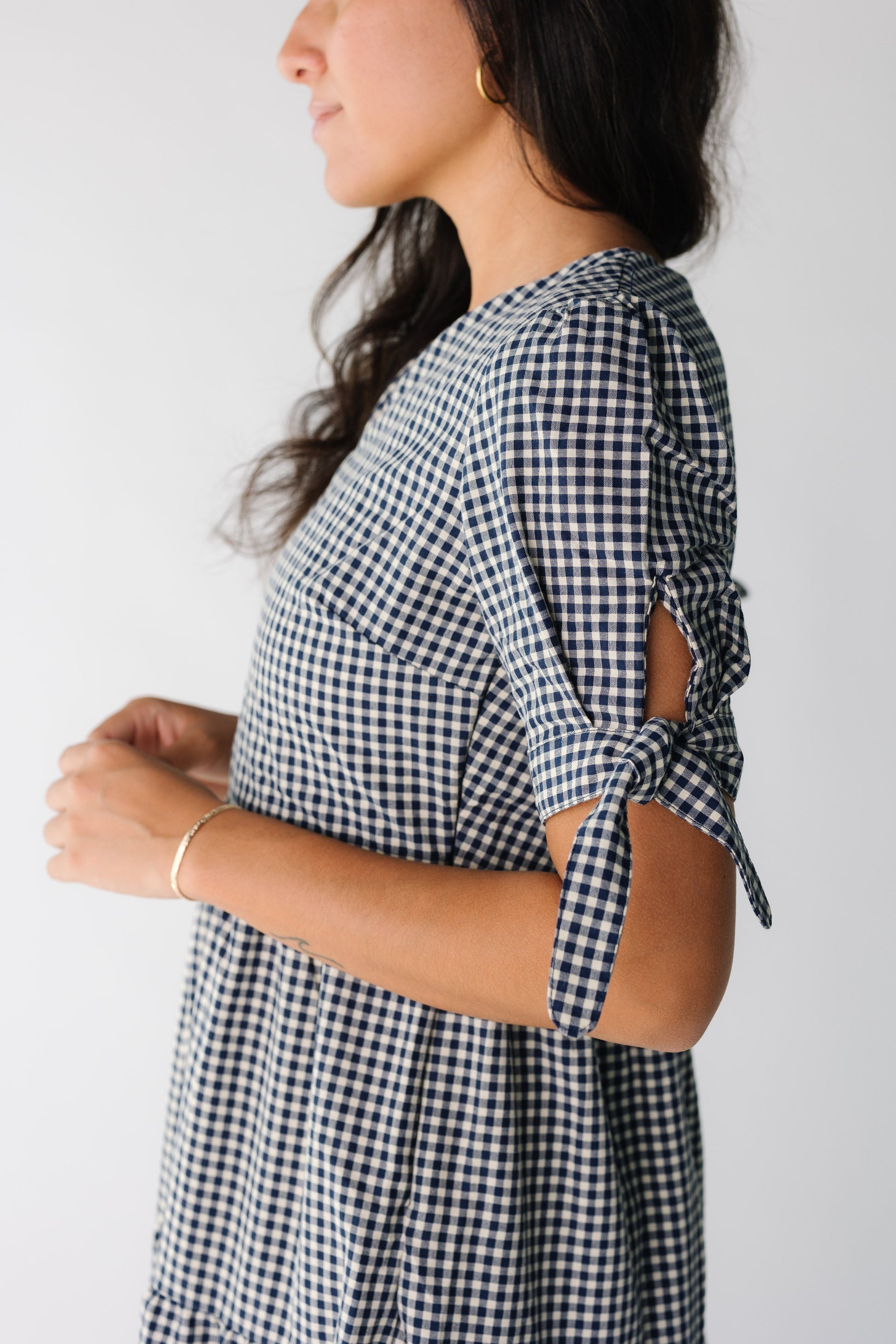 Close view of a short tie sleeve in navy gingham