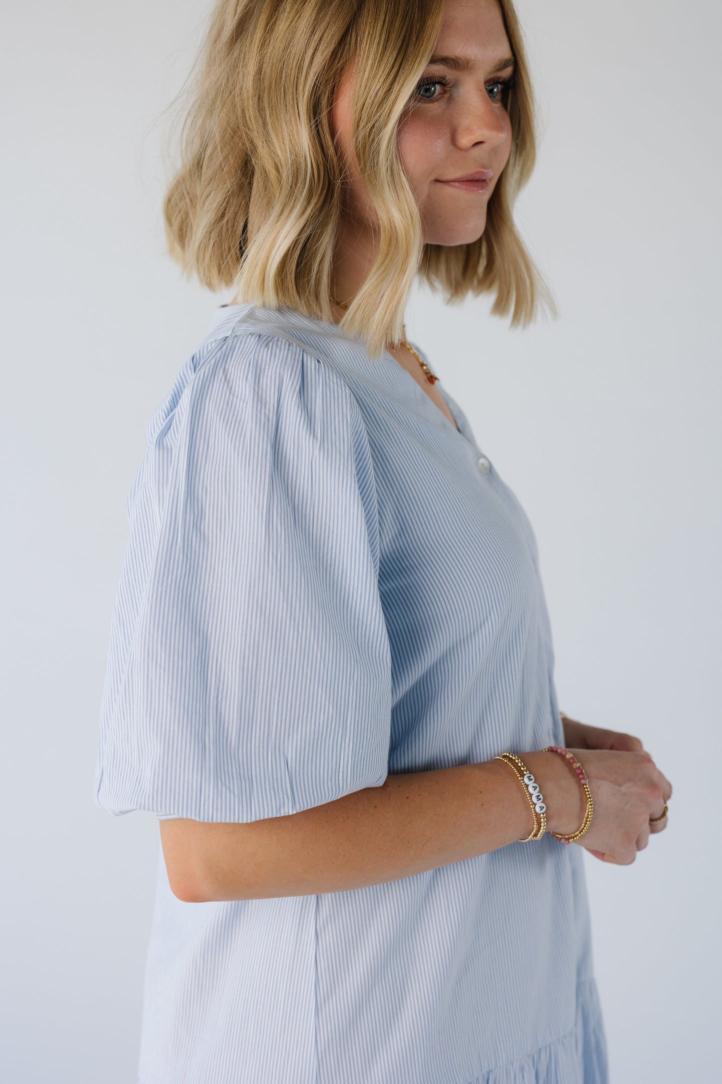 Close side view of large balloon sleeves in light blue stripes