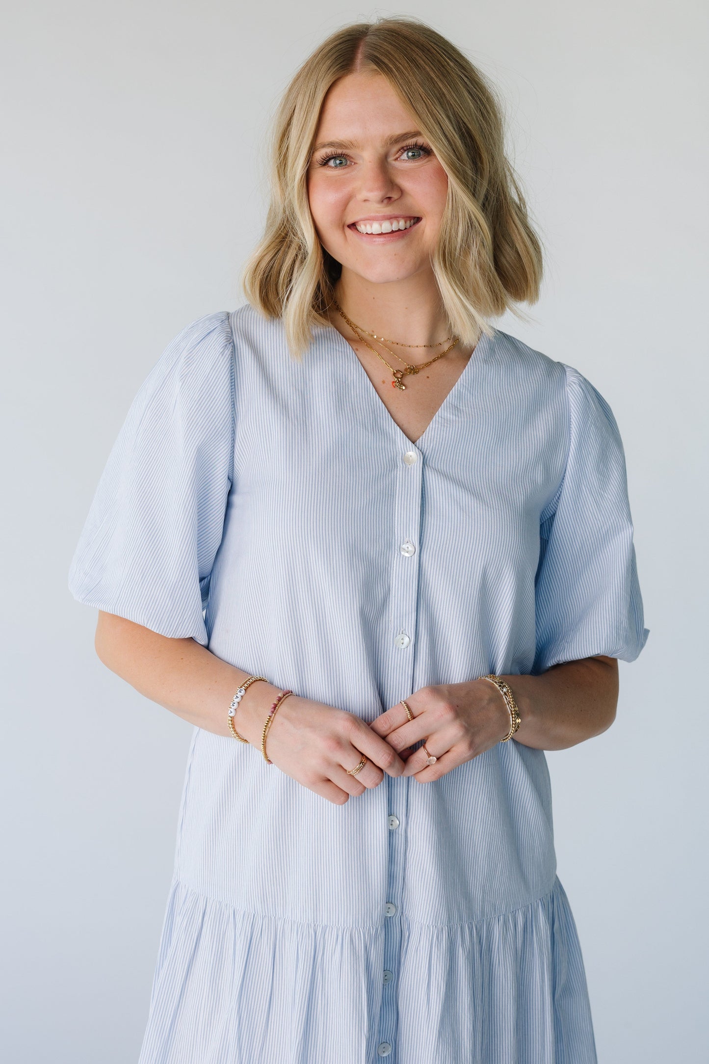 Close view of V-neck dress and half length balloon sleeves