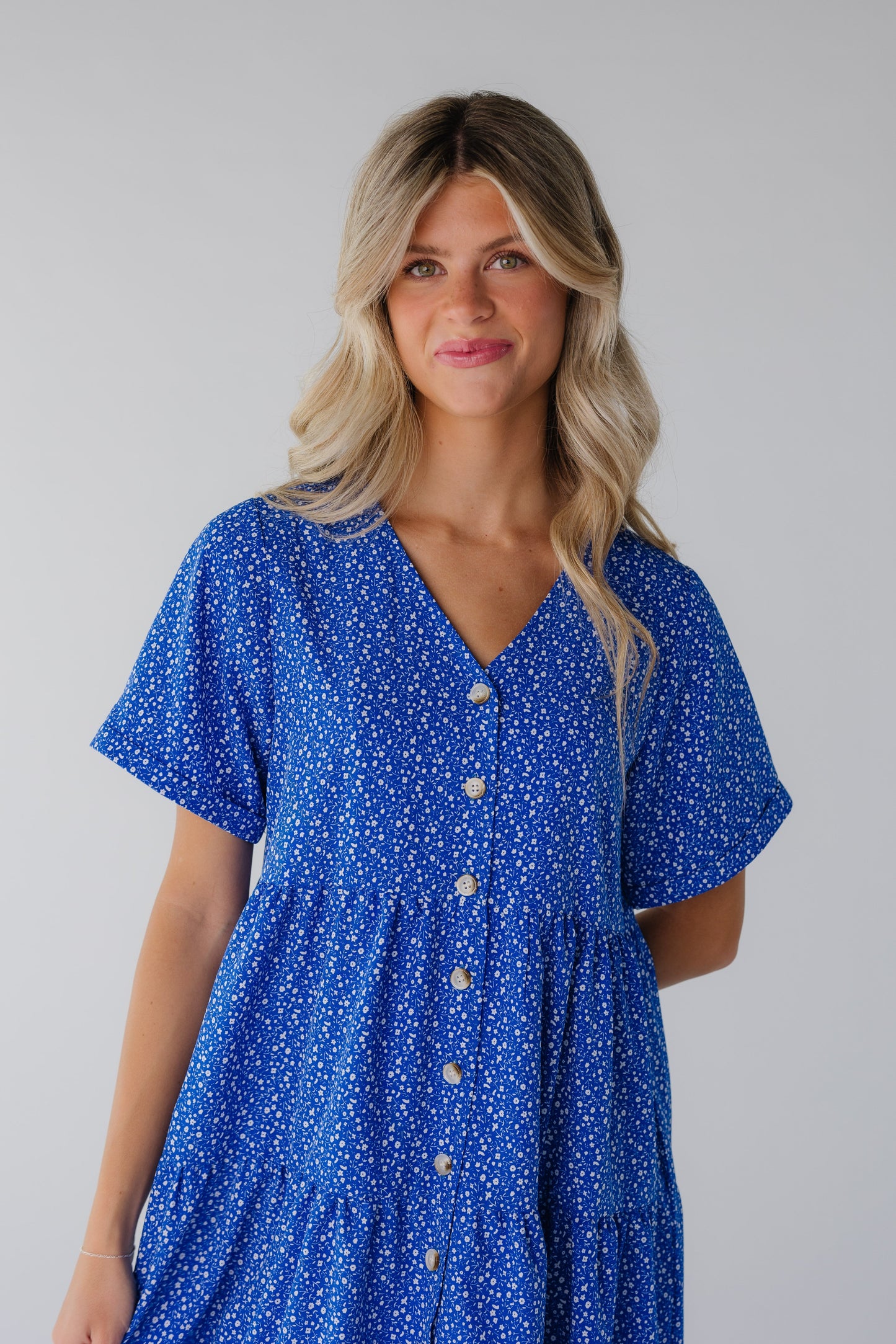 Close view of bright blue button down dress with short sleeves