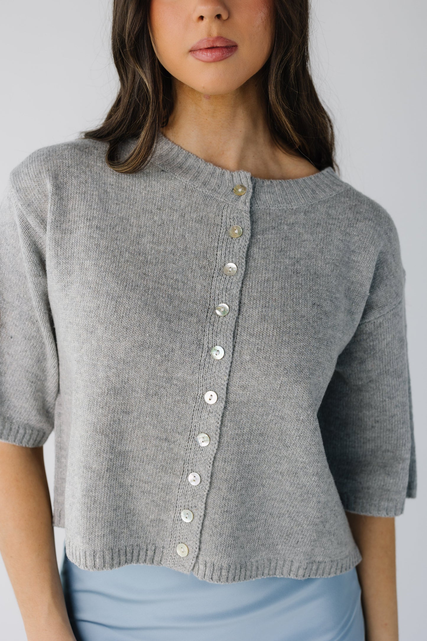 Modest button down cardigan with crew neckline and half length sleeve