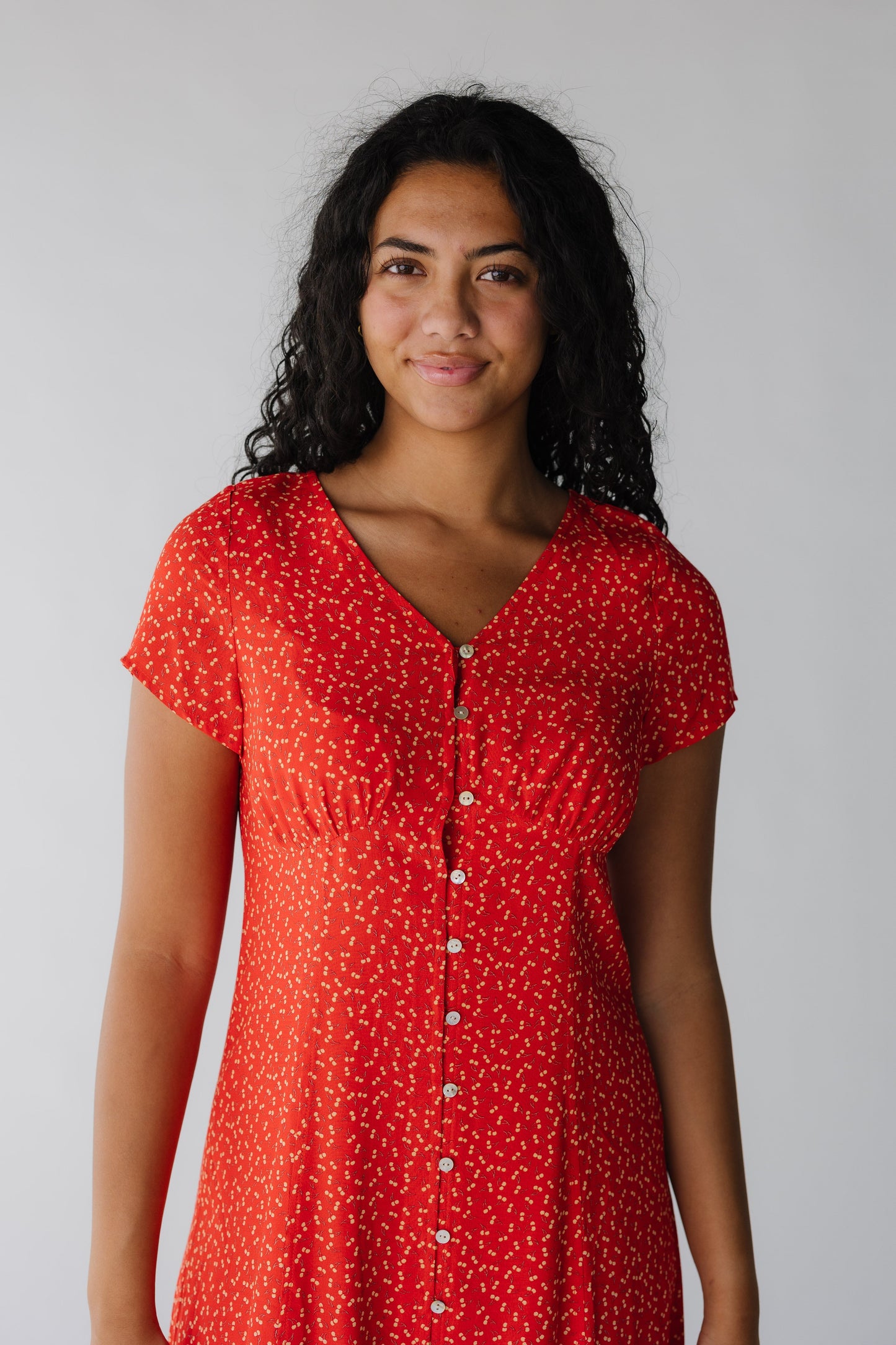 Close view of red cherry print mid with short sleeves