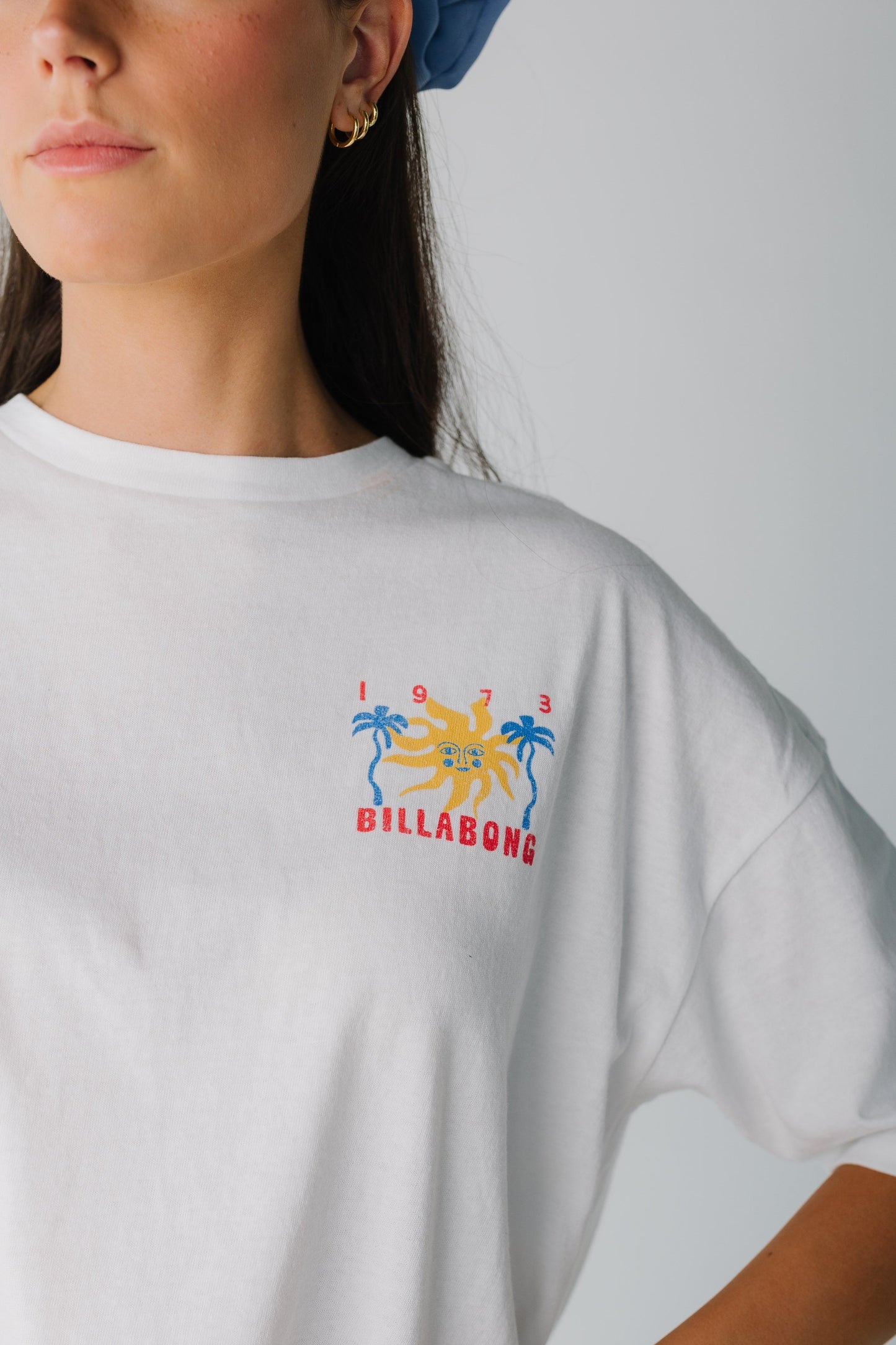 Close view of white graphic tee with small front graphic