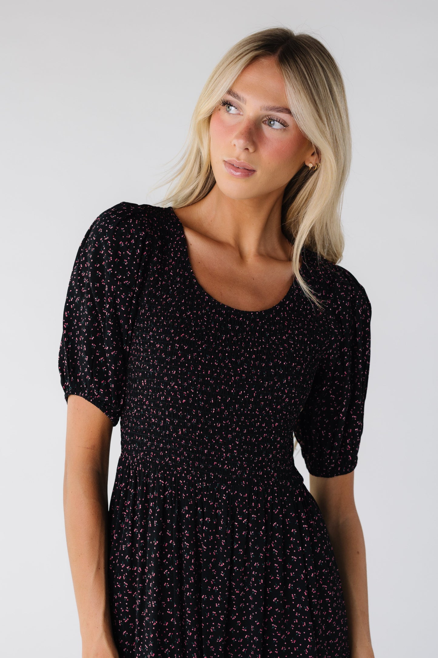 Modest women's black print dress with smocked bodice and scoop neckline