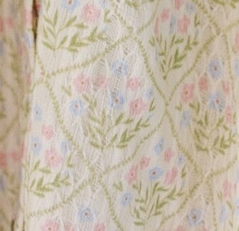 Cream floral fabric swatch.