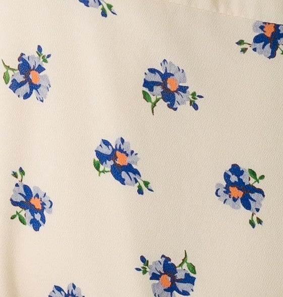 Cream and blue floral fabric swatch.
