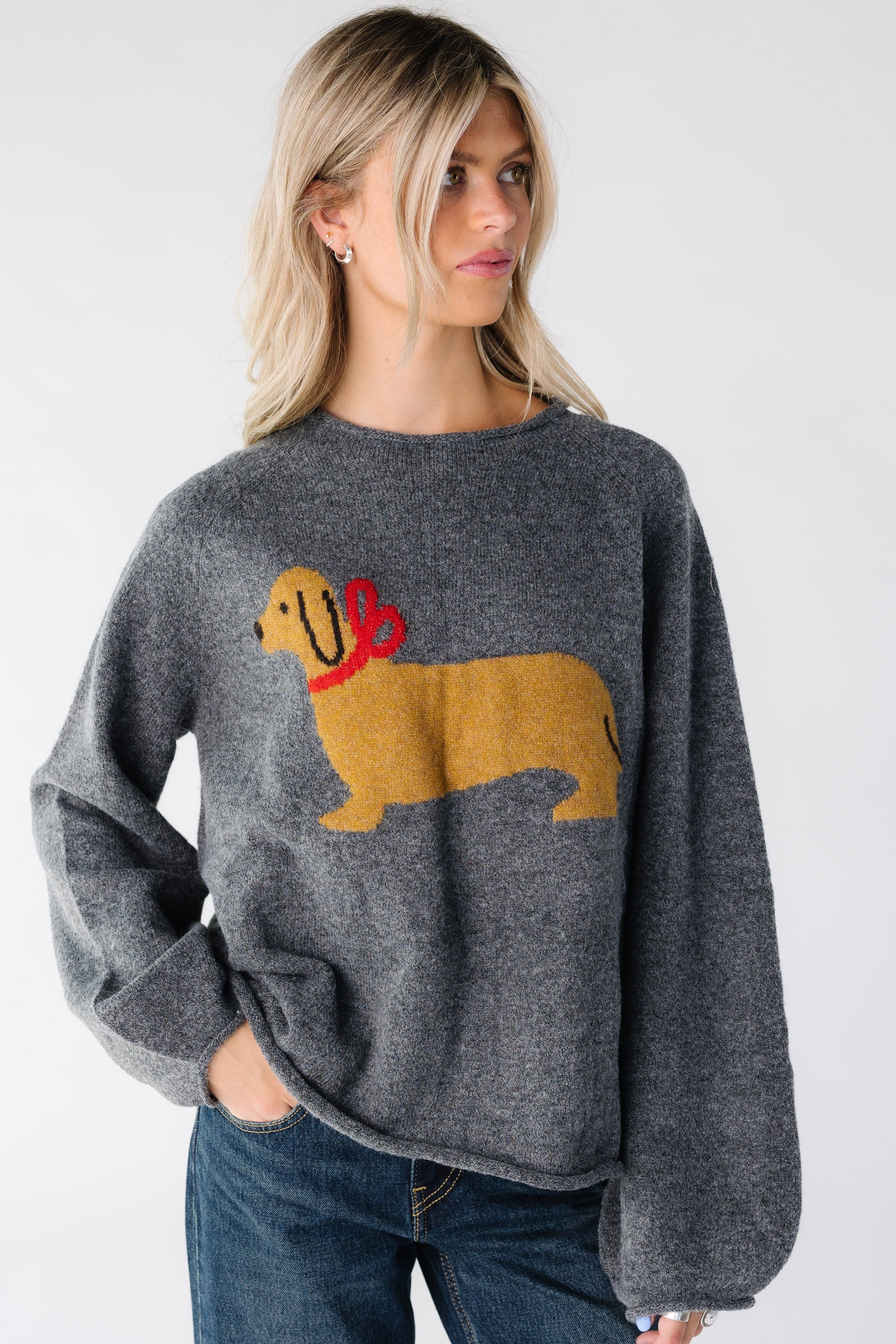 Women wearing a charcoal long sleeve sweater with large dog graphic