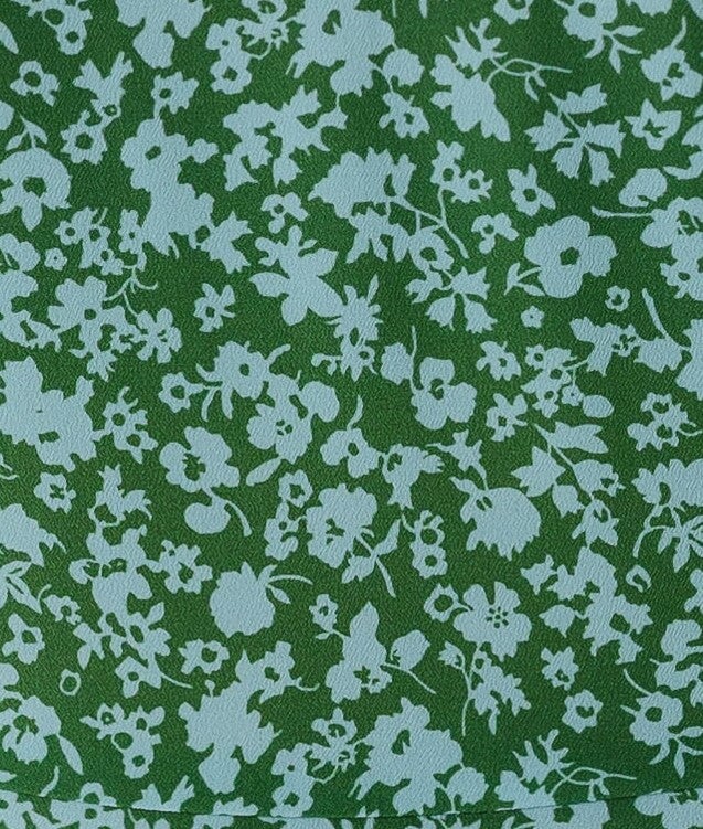 green and light blue floral print fabric swatch.
