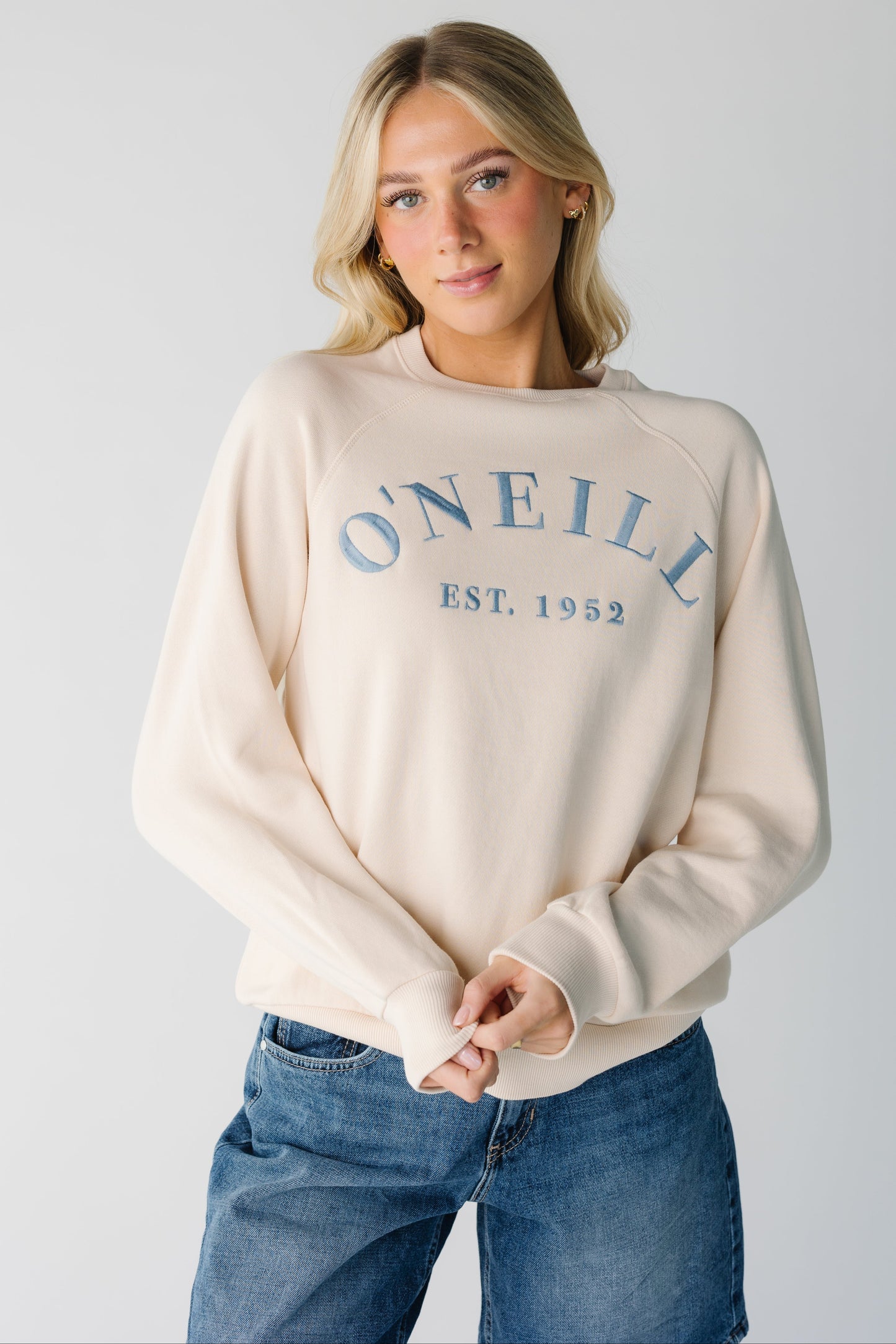 Modest women's O'Neill sweatshirt if off white with crew neckline and long sleeves