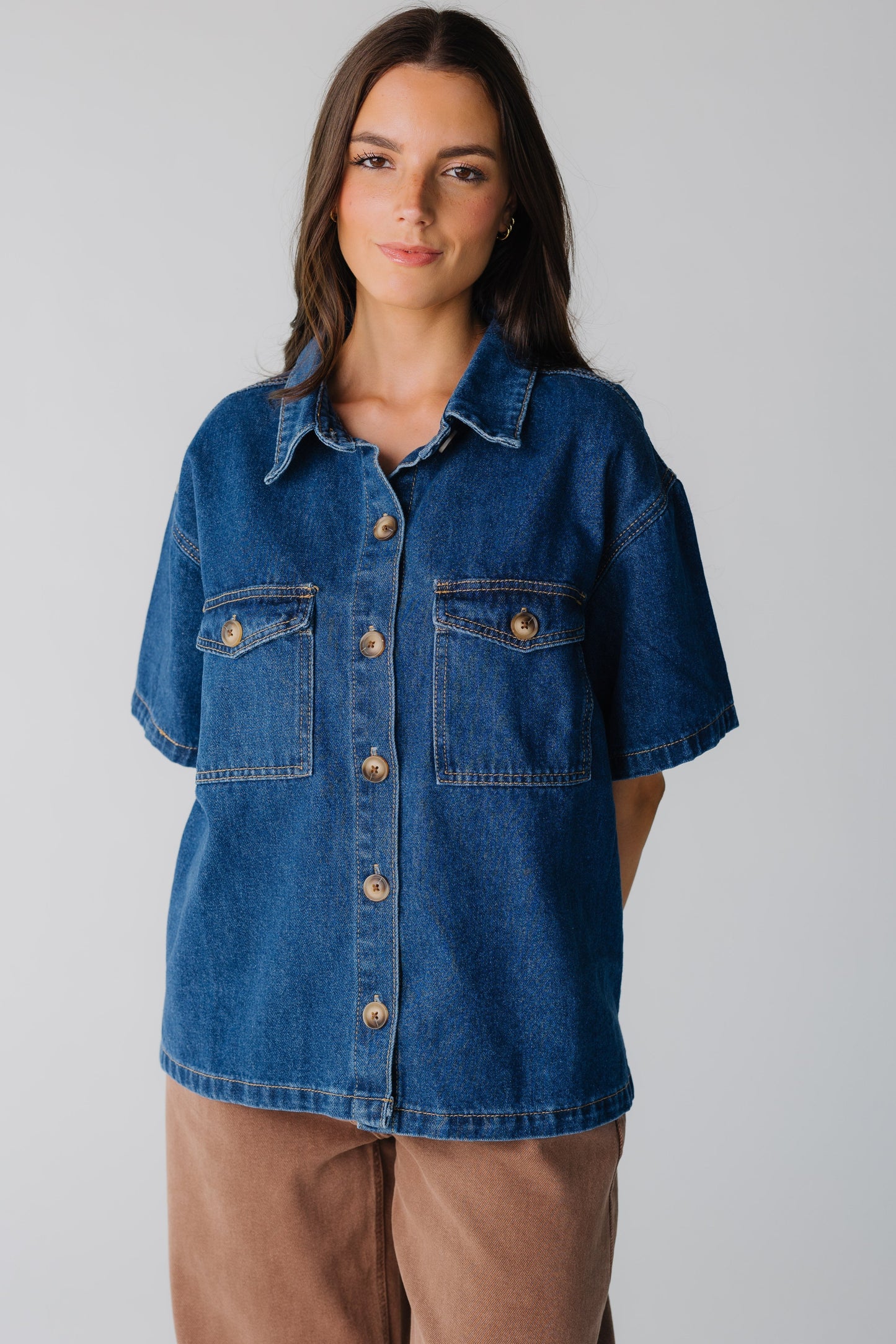 Modest women's loose denim shirt with short sleeves and pointed collar