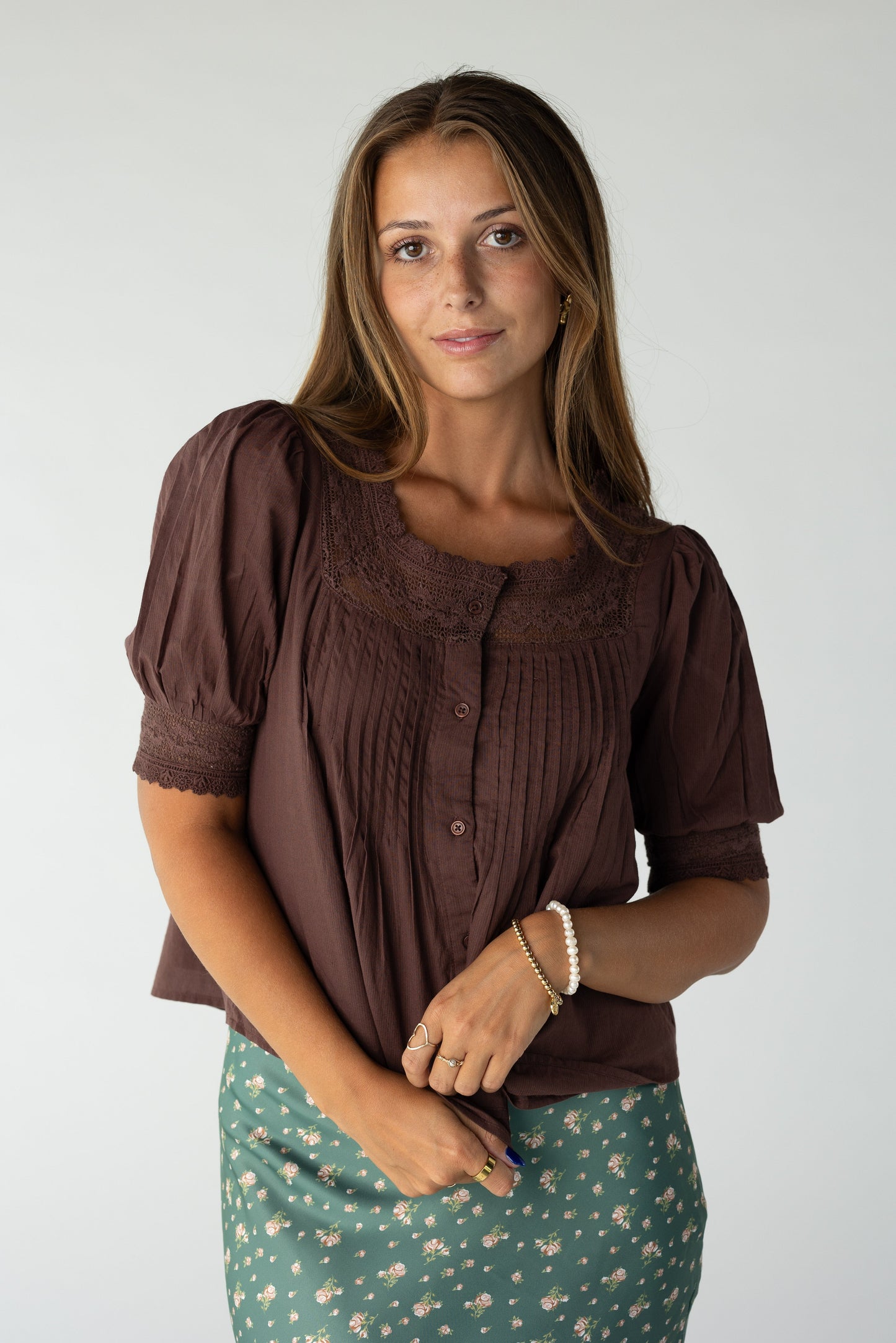 Woman wearing a dark brown button down top