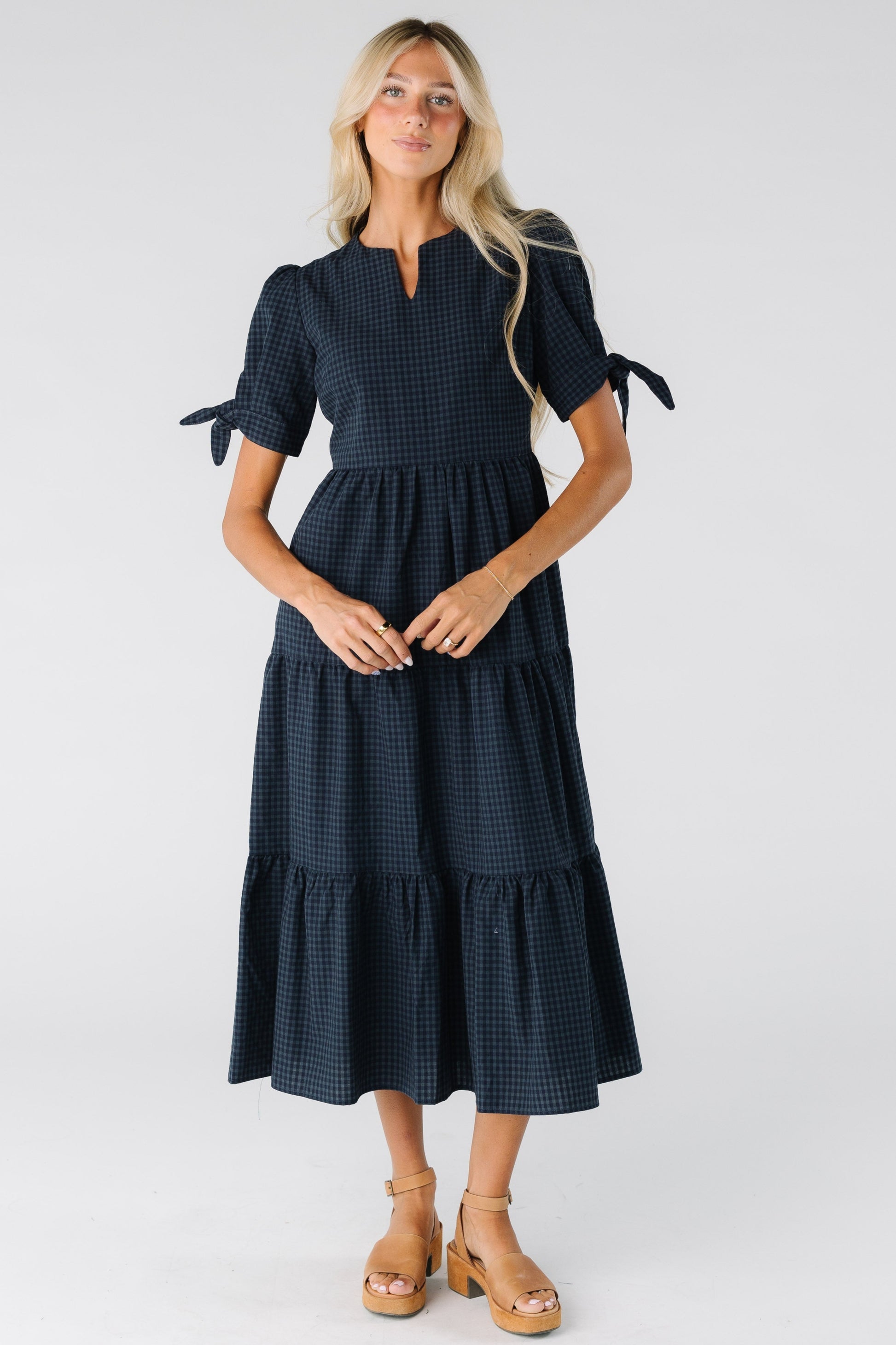 Woman wearing a navy gingham midi with short sleeves
